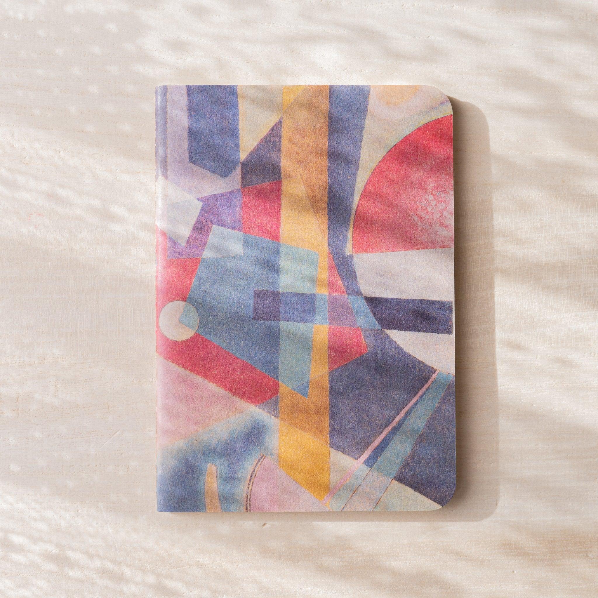 RO-BIKI NOTE Museum Series waxed cover with abstract geometric painting in blue, red, yellow, and pink tones, no belly band