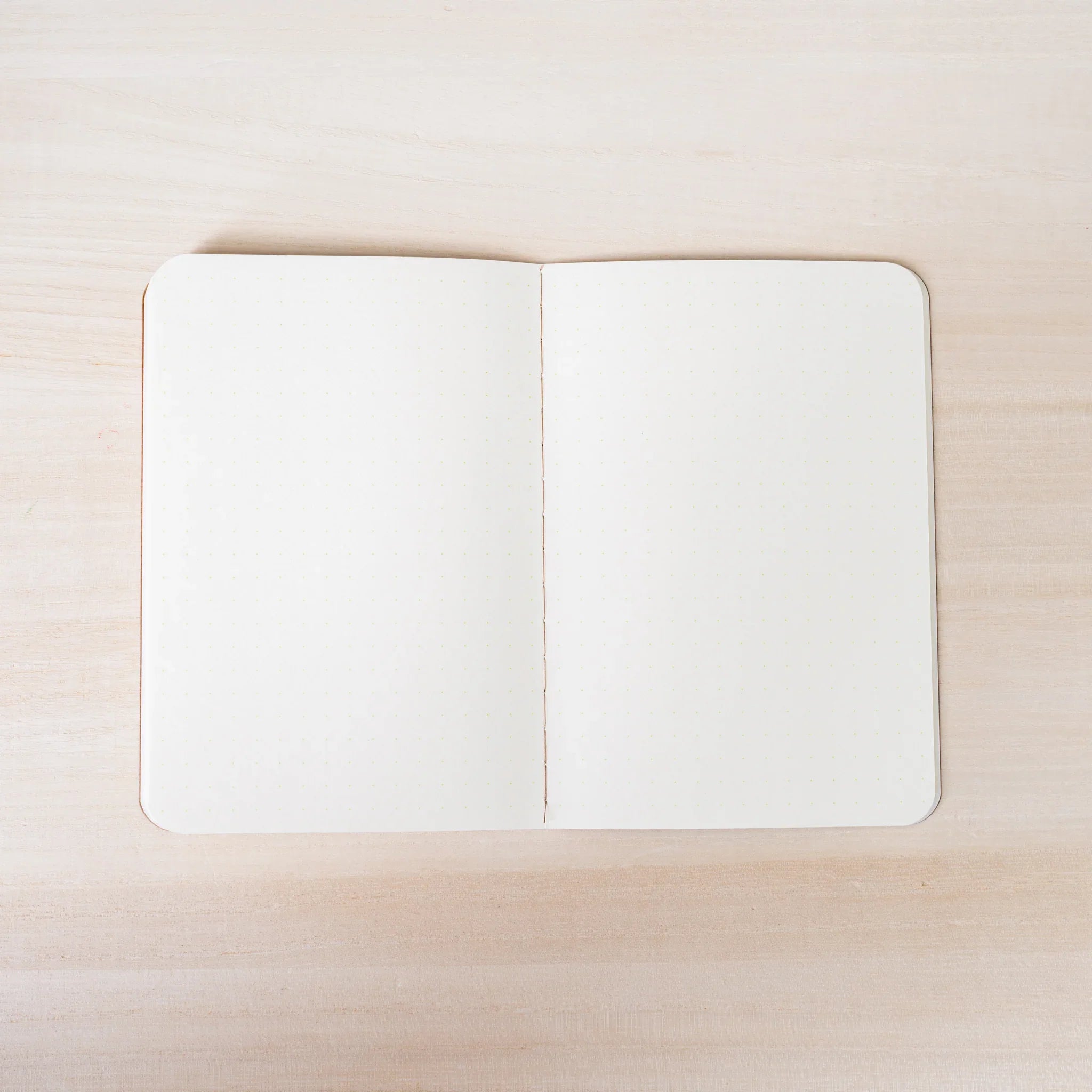 RO-BIKI NOTE open to ivory dot grid spread, both pages with 5mm dot pattern, rounded corners and center spine visible