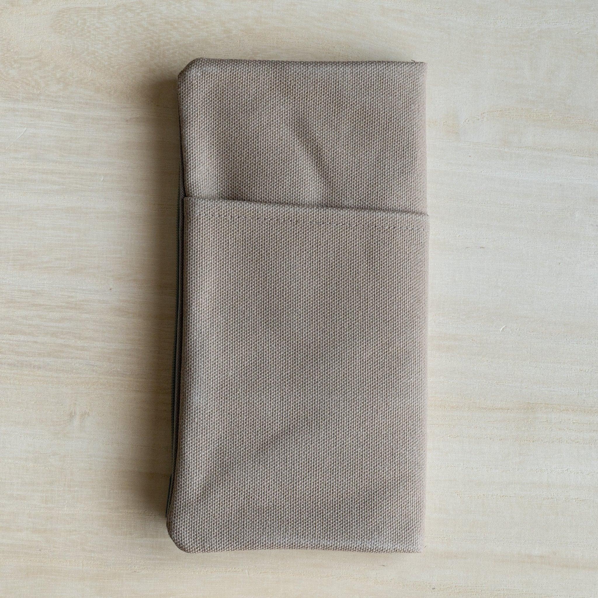 RO-BIKI clay beige canvas cover closed and laid flat, front view in clay beige cotton canvas