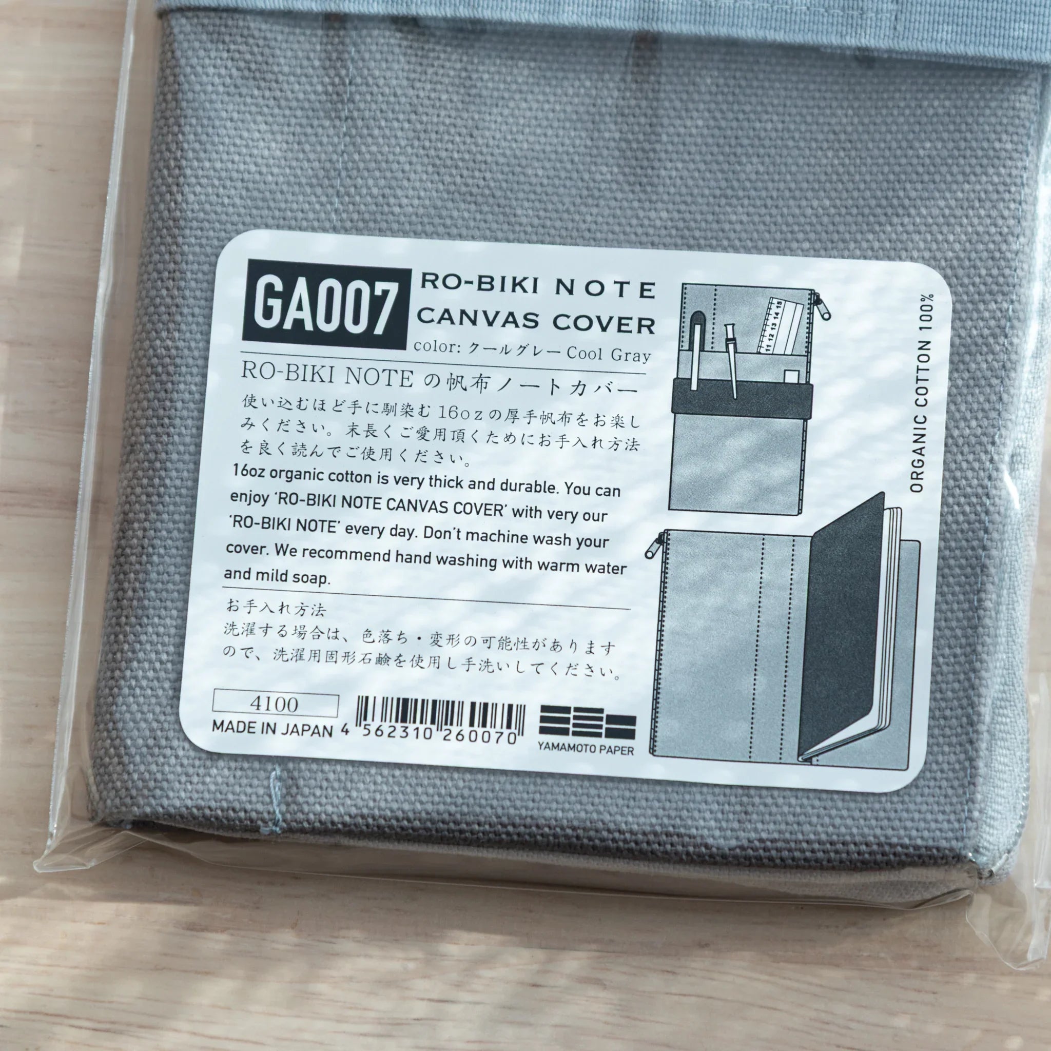 Instruction sheet on RO-BIKI Canvas Cover Cool Gray packaging, showing usage with Japanese Note Book and pens.