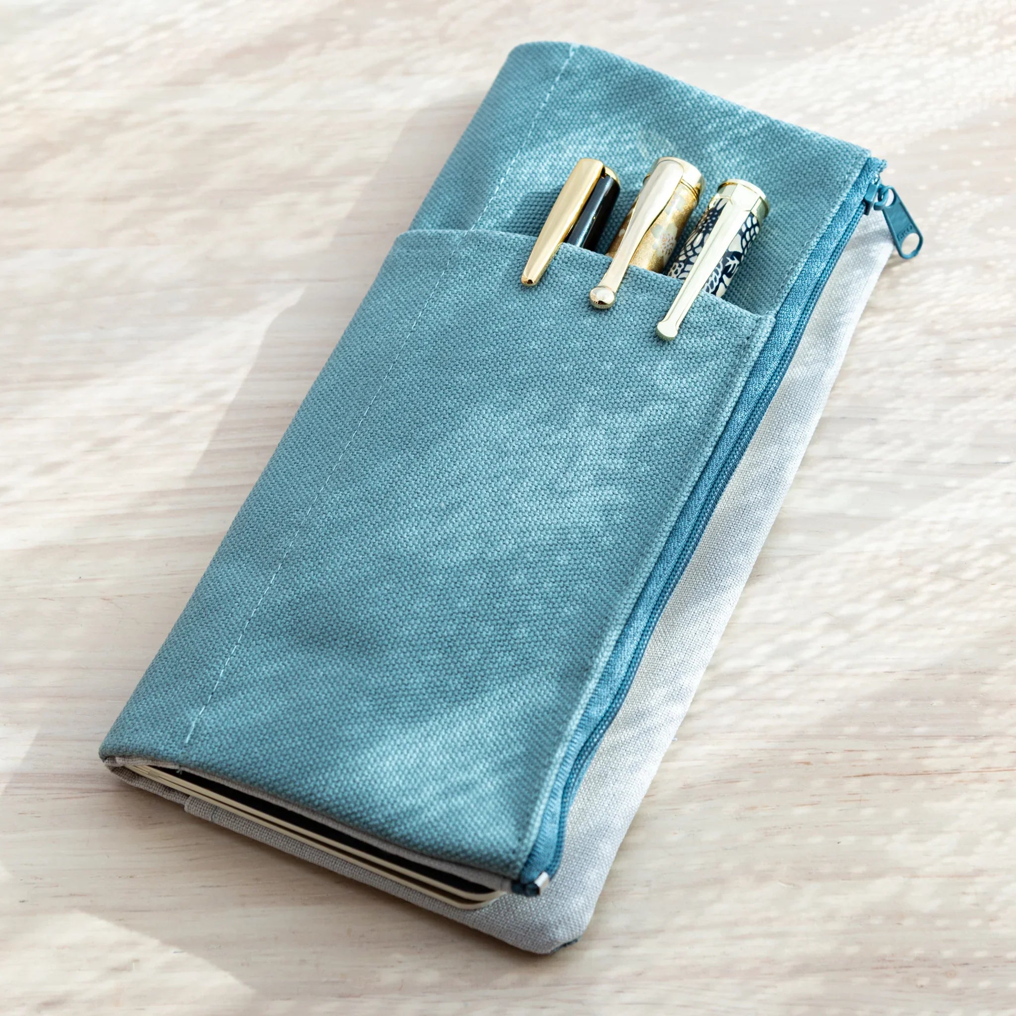 Blue canvas RO-BIKI NOTE Japanese Note Book Cover with pen pockets and zipper for storage and organization.