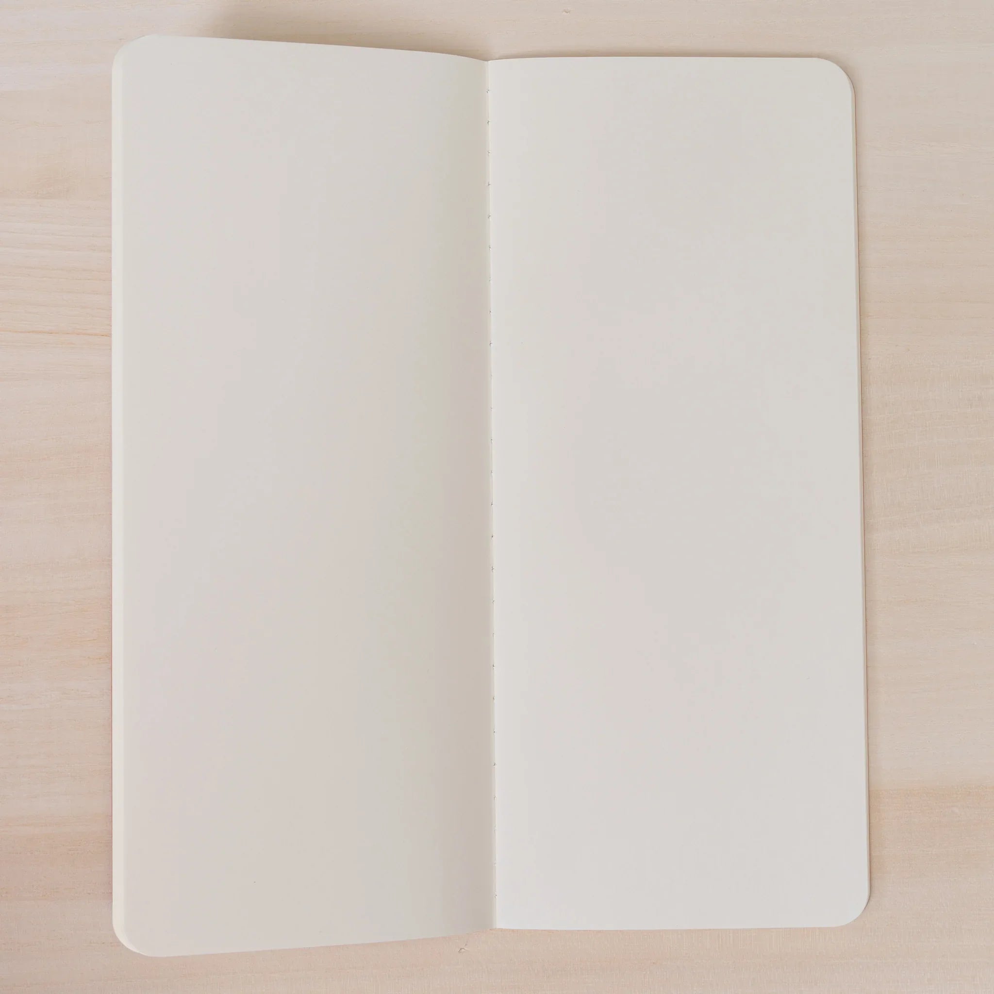 RO-BIKI NOTE Edocha Brown notebook spread open displaying smooth blank cream pages ideal for journaling and sketching
