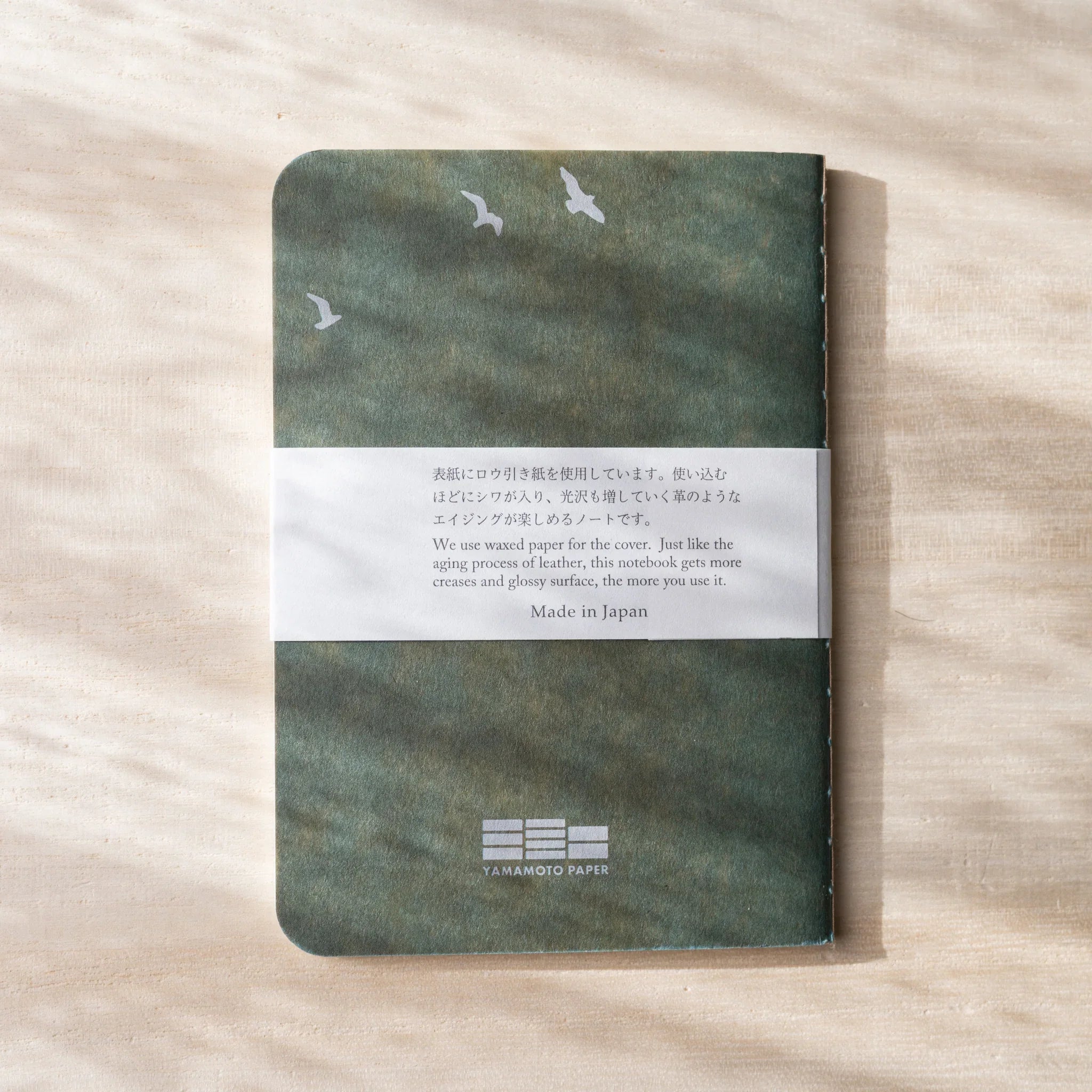 RO-BIKI NOTE Japanese notebook back cover, sage green waxed cover with bird silhouettes, belly band with Made in Japan text