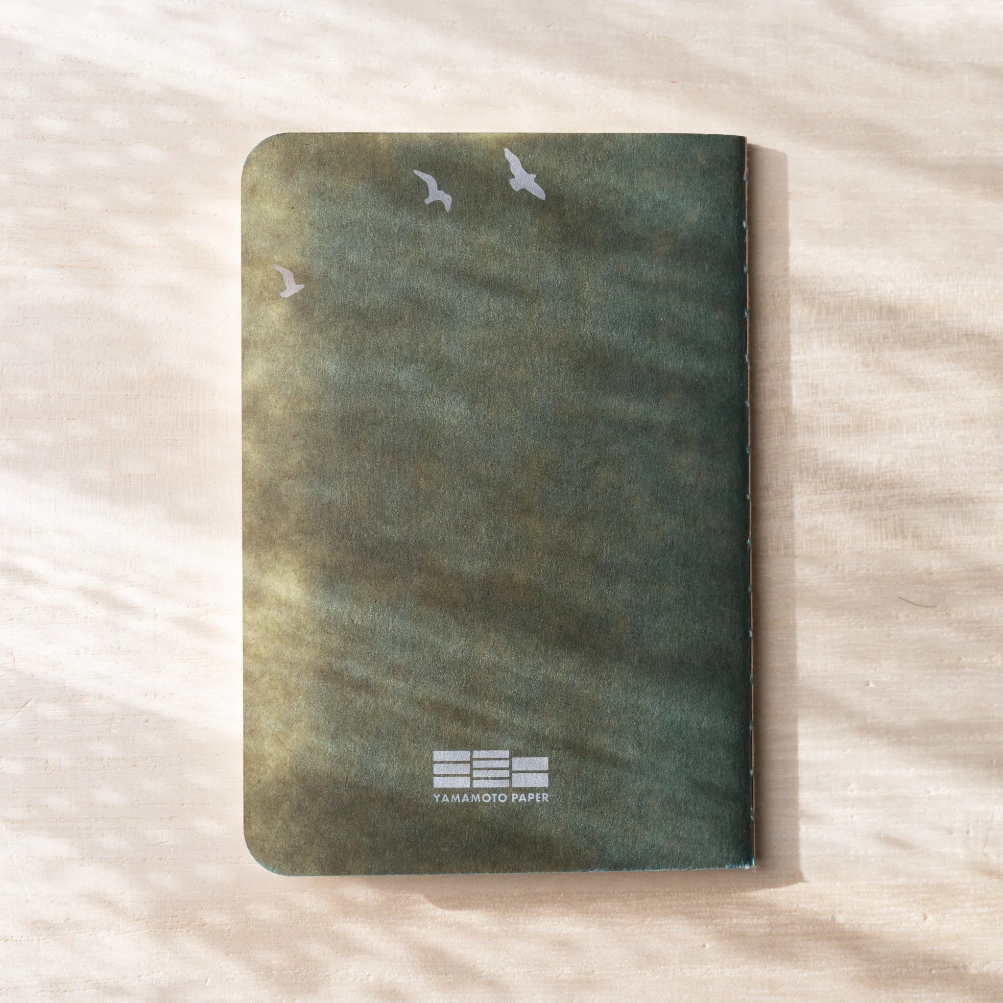 RO-BIKI NOTE Japanese notebook back cover, sage green waxed kraft cover with small bird silhouettes, Yamamoto Paper logo