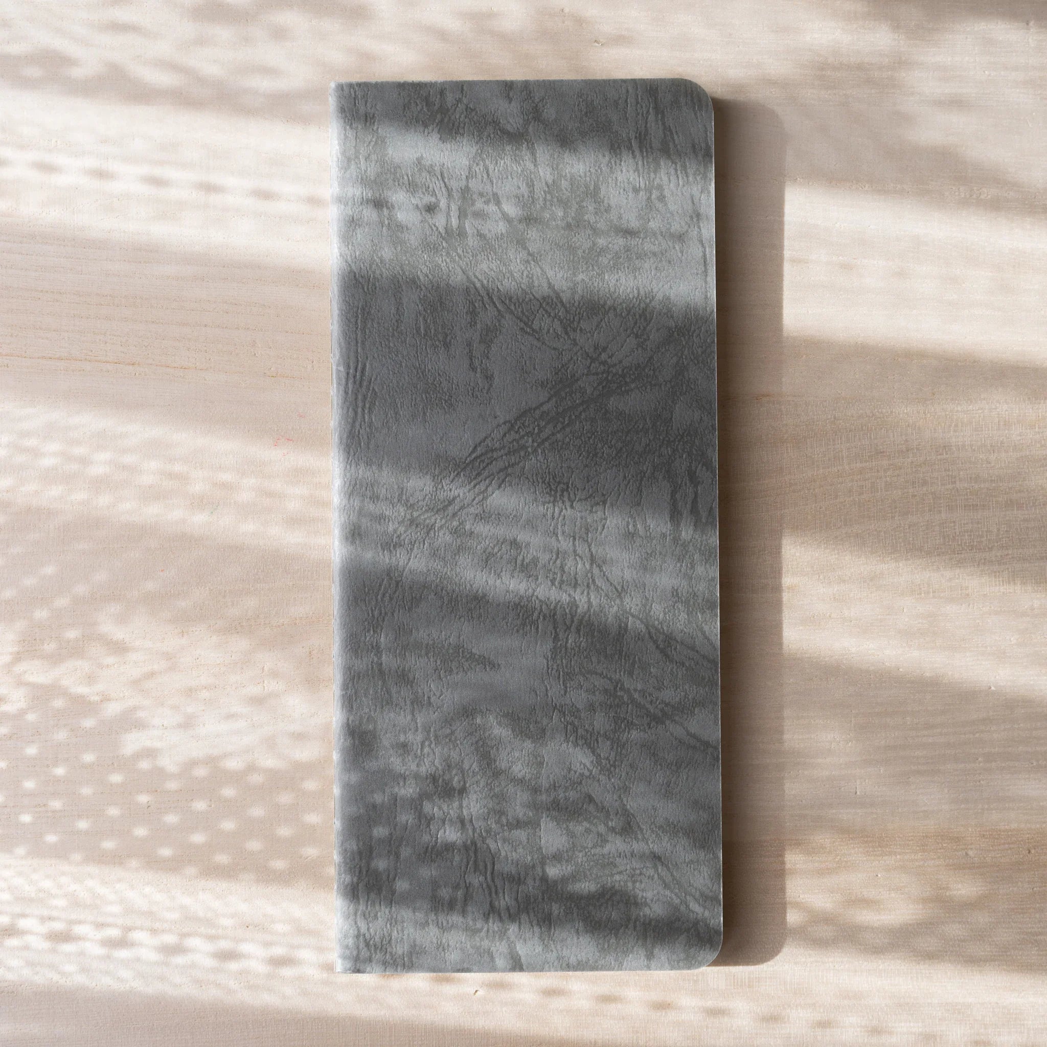 RO-BIKI NOTE Ginnezu gray wax-coated notebook back cover showing textured marbled wax coating pattern