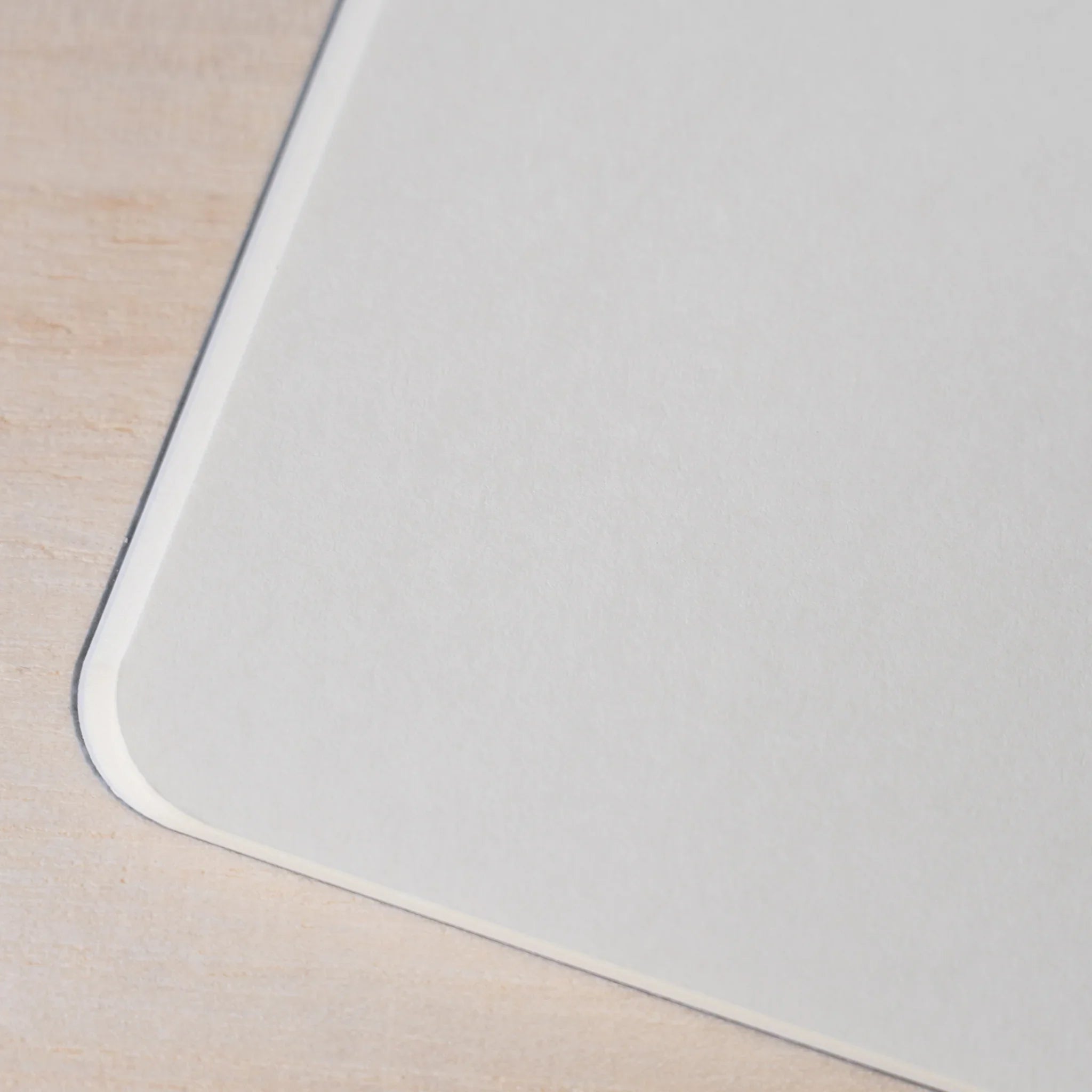 Close-up of RO-BIKI NOTE Ginnezu gray notebook rounded corner showing smooth cream blank page detail