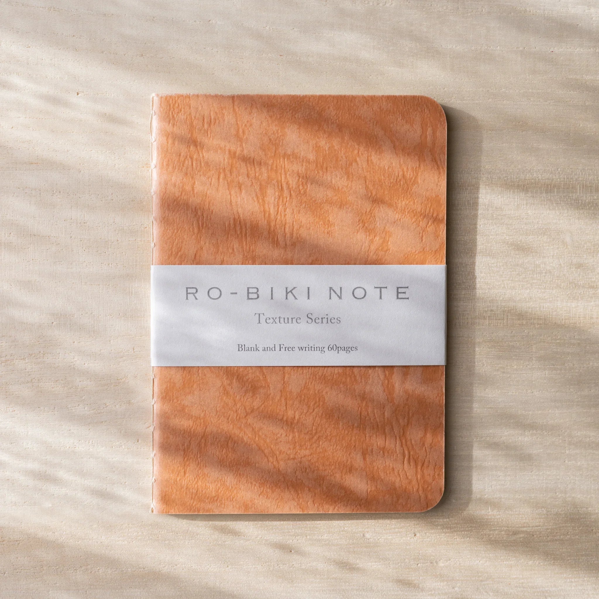 RO-BIKI NOTE Japanese notebook, coral red waxed cover with wood-grain texture, belly band with Texture Series text