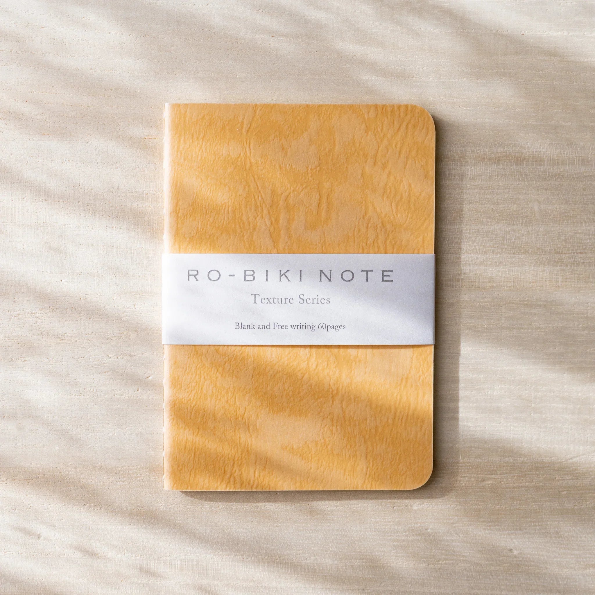 RO-BIKI NOTE Japanese notebook, amber waxed cover with wood-grain texture, belly band with Texture Series text