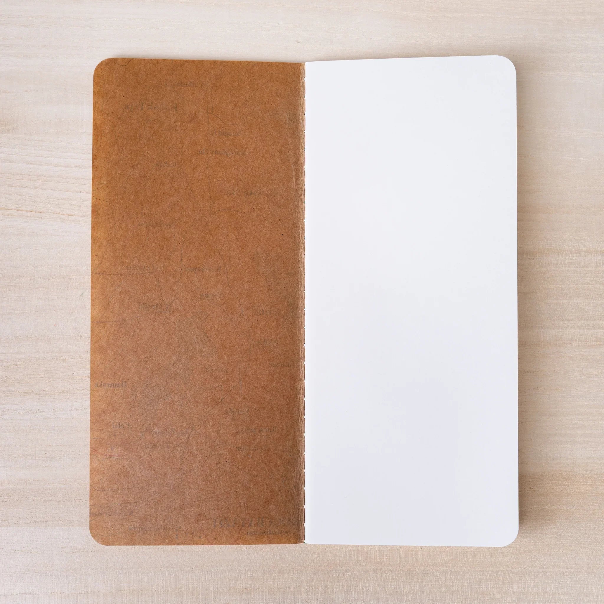RO-BIKI NOTE Topographical Map notebook opened flat showing wax-coated cover and blank white interior pages