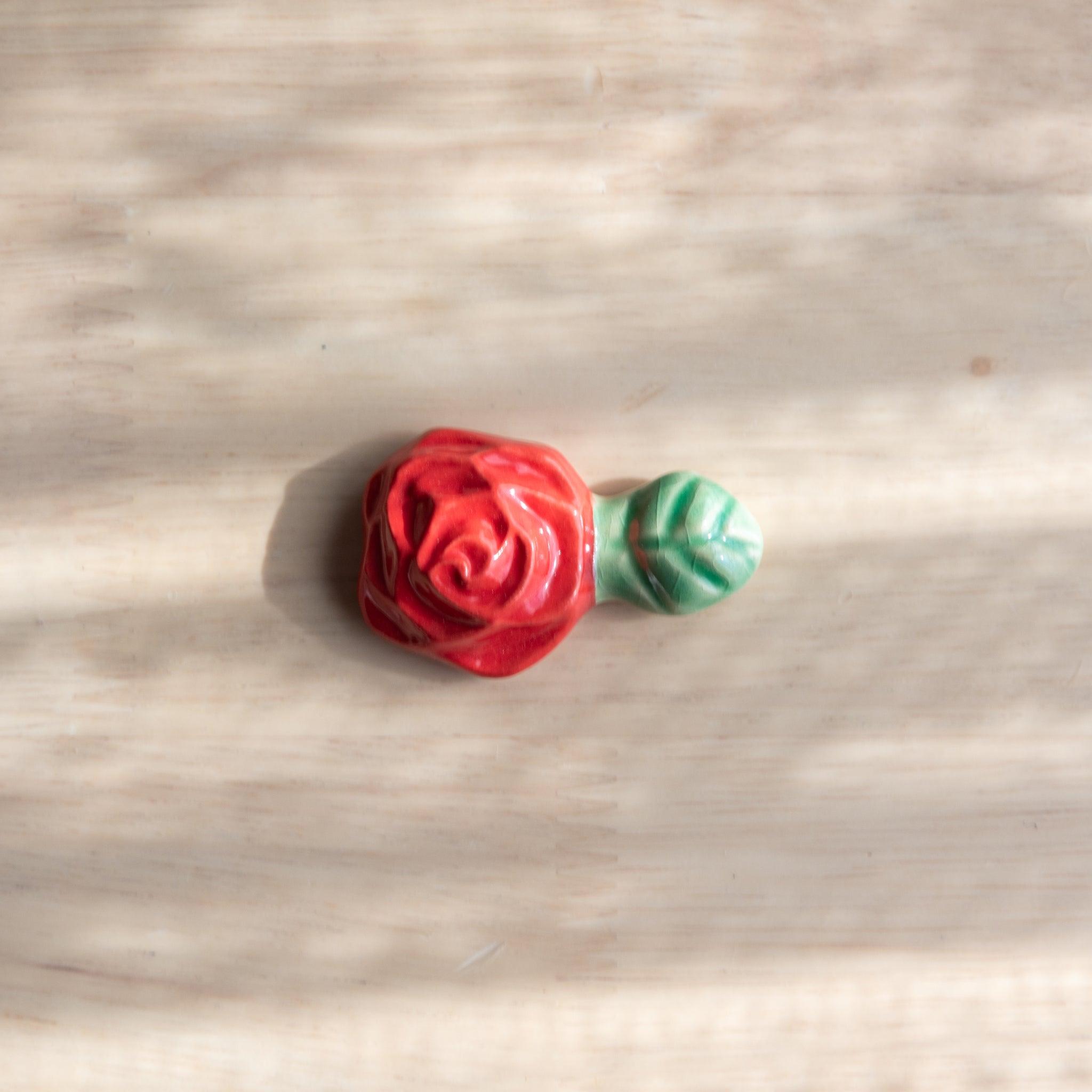 Handcrafted ceramic pen rest shaped like a pink rose, adding elegance to Japanese stationery collections.