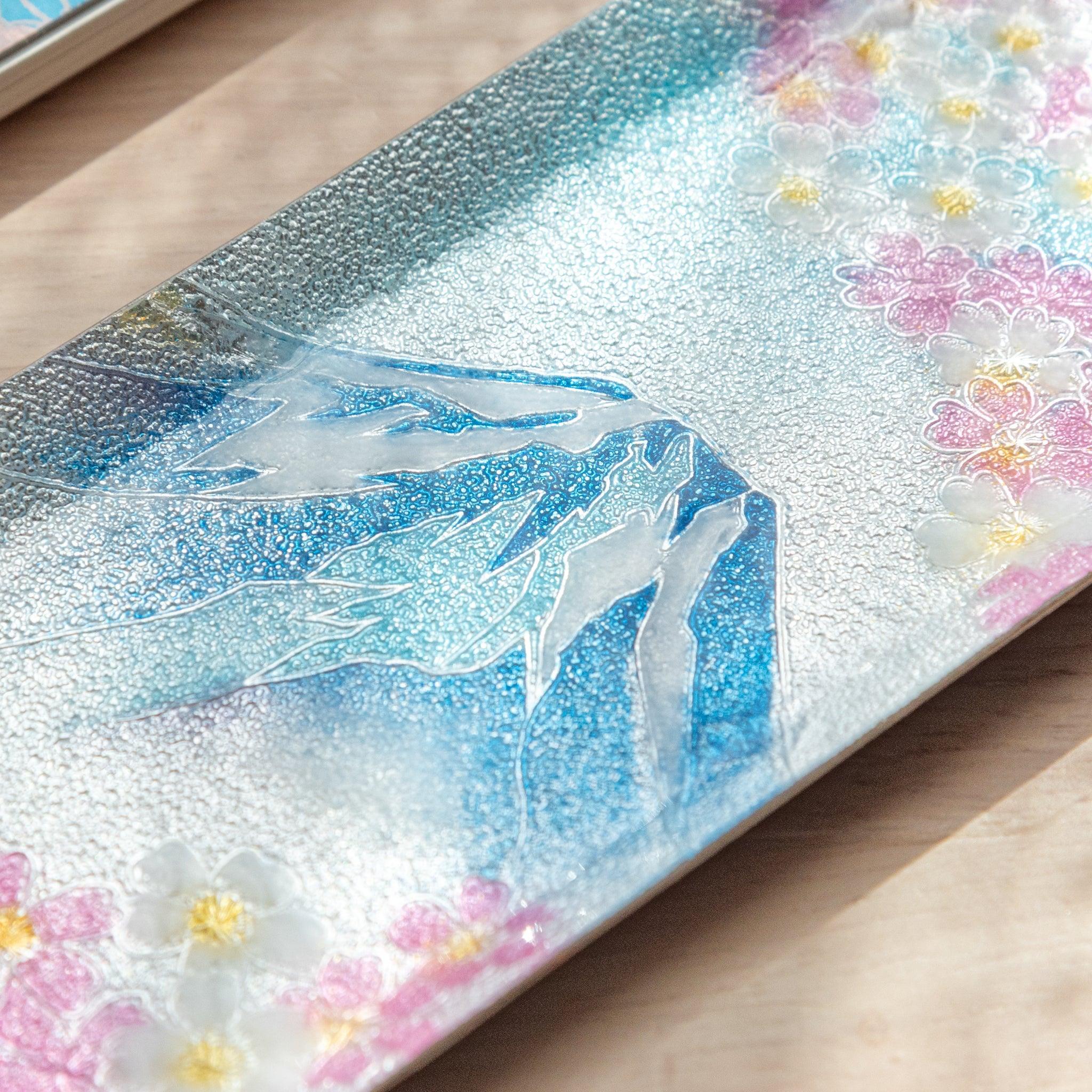 Close-up of Mt. Fuji and cherry blossoms design on a tray, highlighting detailed textures of the mountain and flower petals.