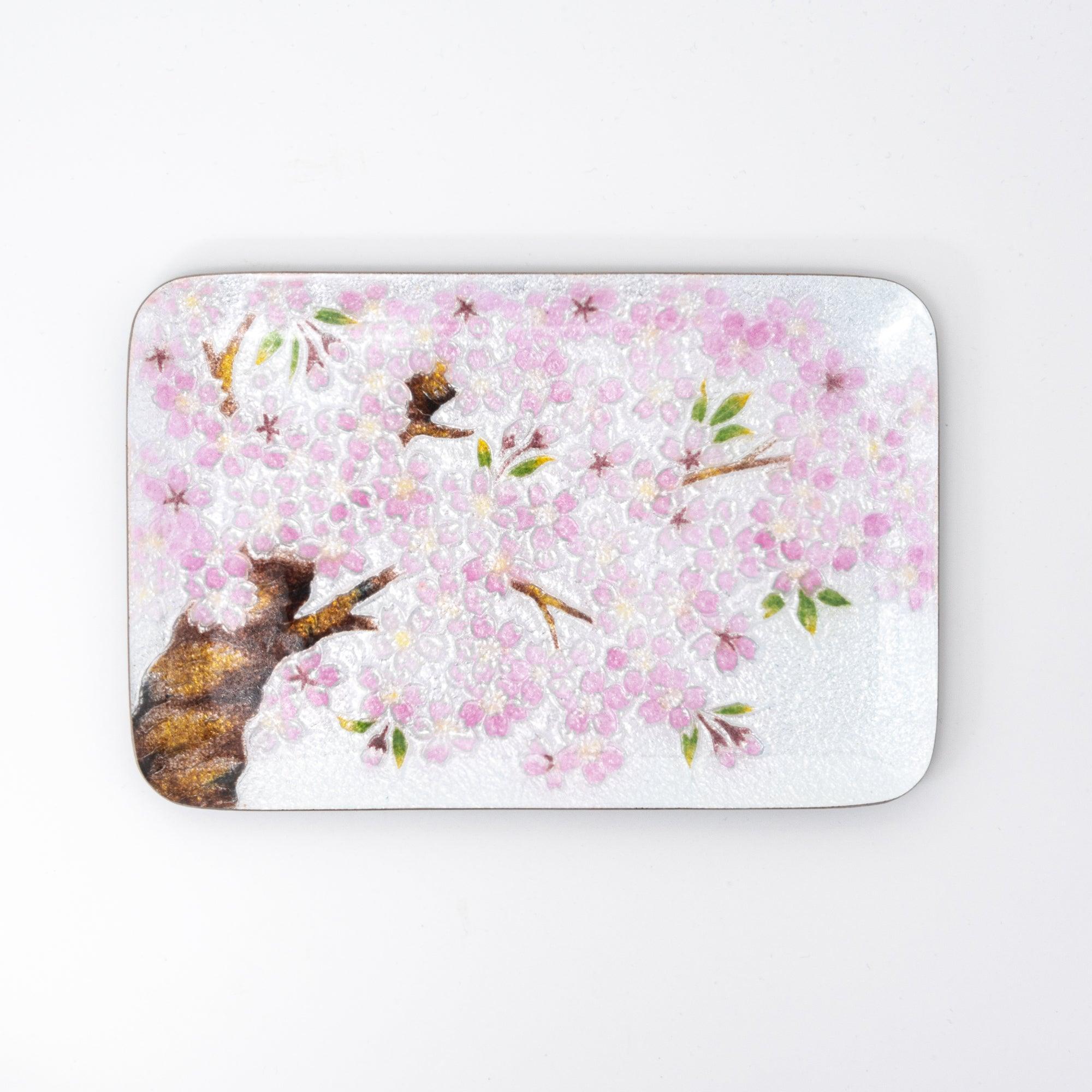 Flat view of a decorative tray with pink cherry blossoms, showcasing intricate details and delicate floral artwork.  