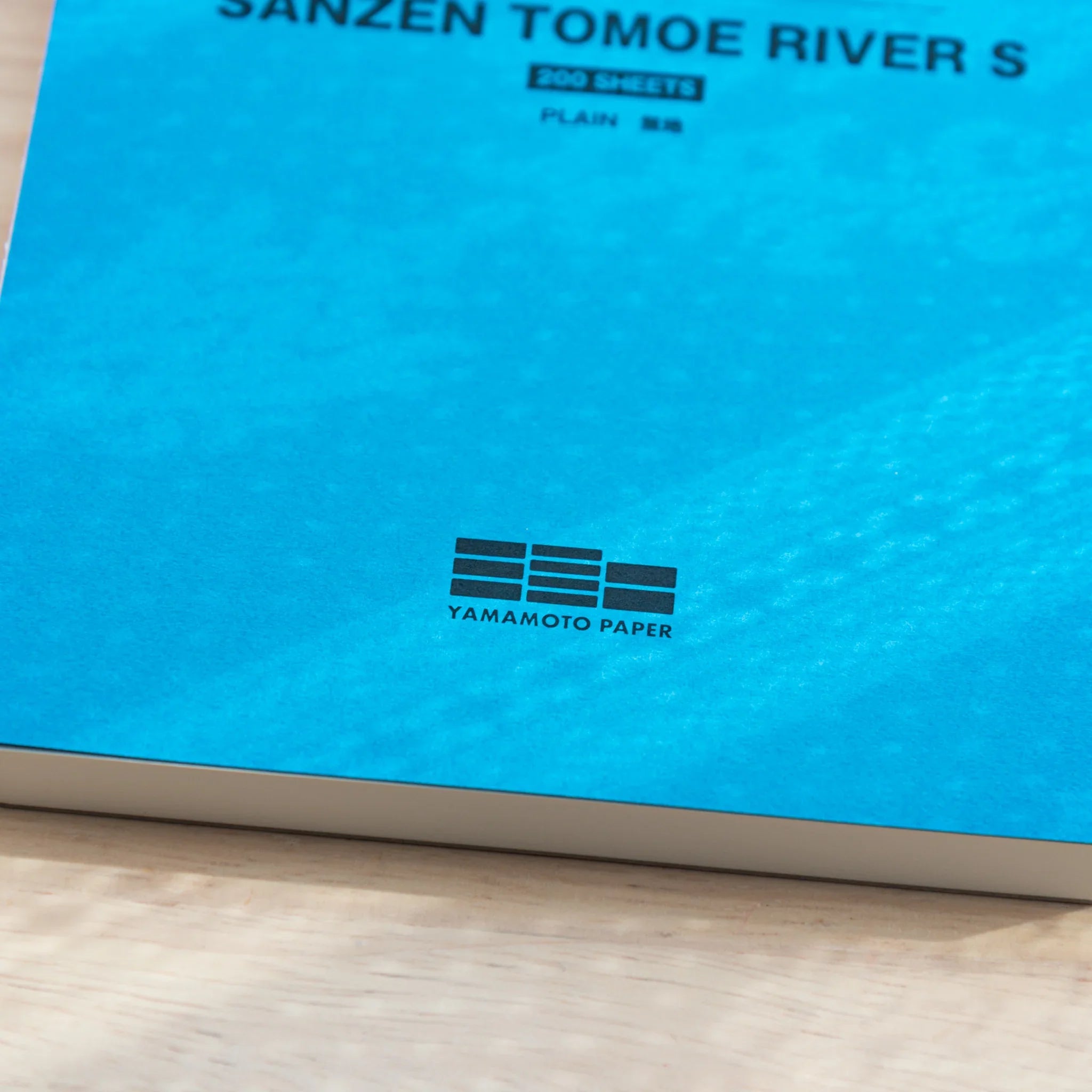 Detail of Yamamoto Paper logo on Sanzen Tomoe River A5 Japanese Writing Pad, plain premium writing pad.
