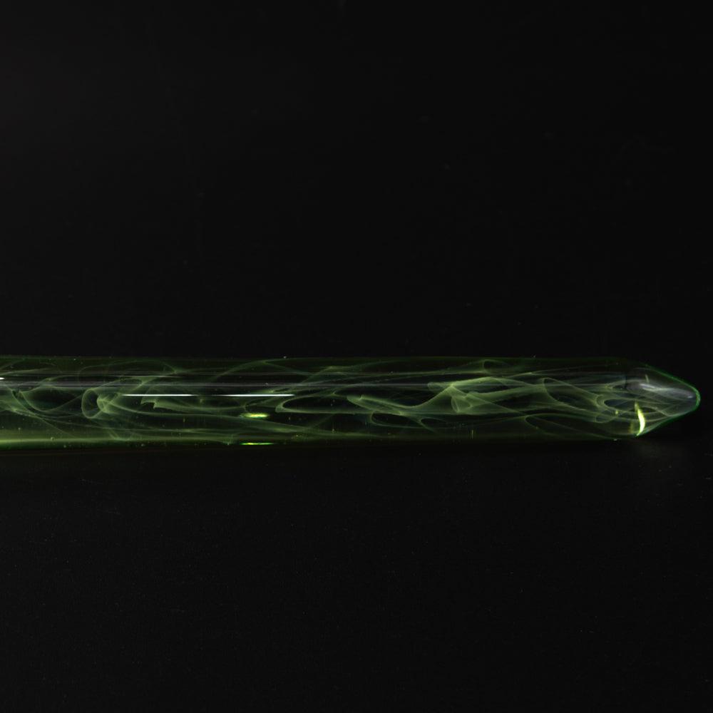 Dark background highlights the green glass pen's intricate design, showcasing the swirling patterns inside the translucent body.