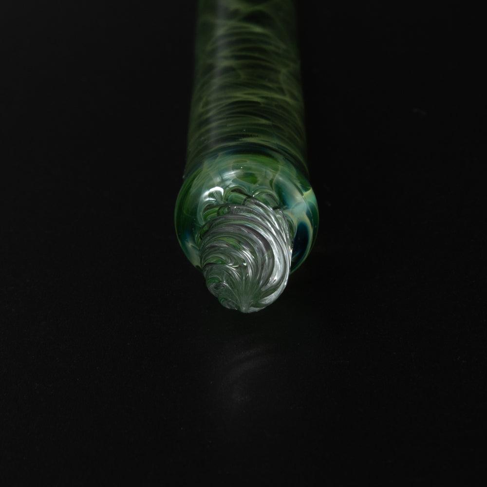 Dark background highlights the green glass pen's intricate design, showcasing the swirling patterns inside the translucent body.