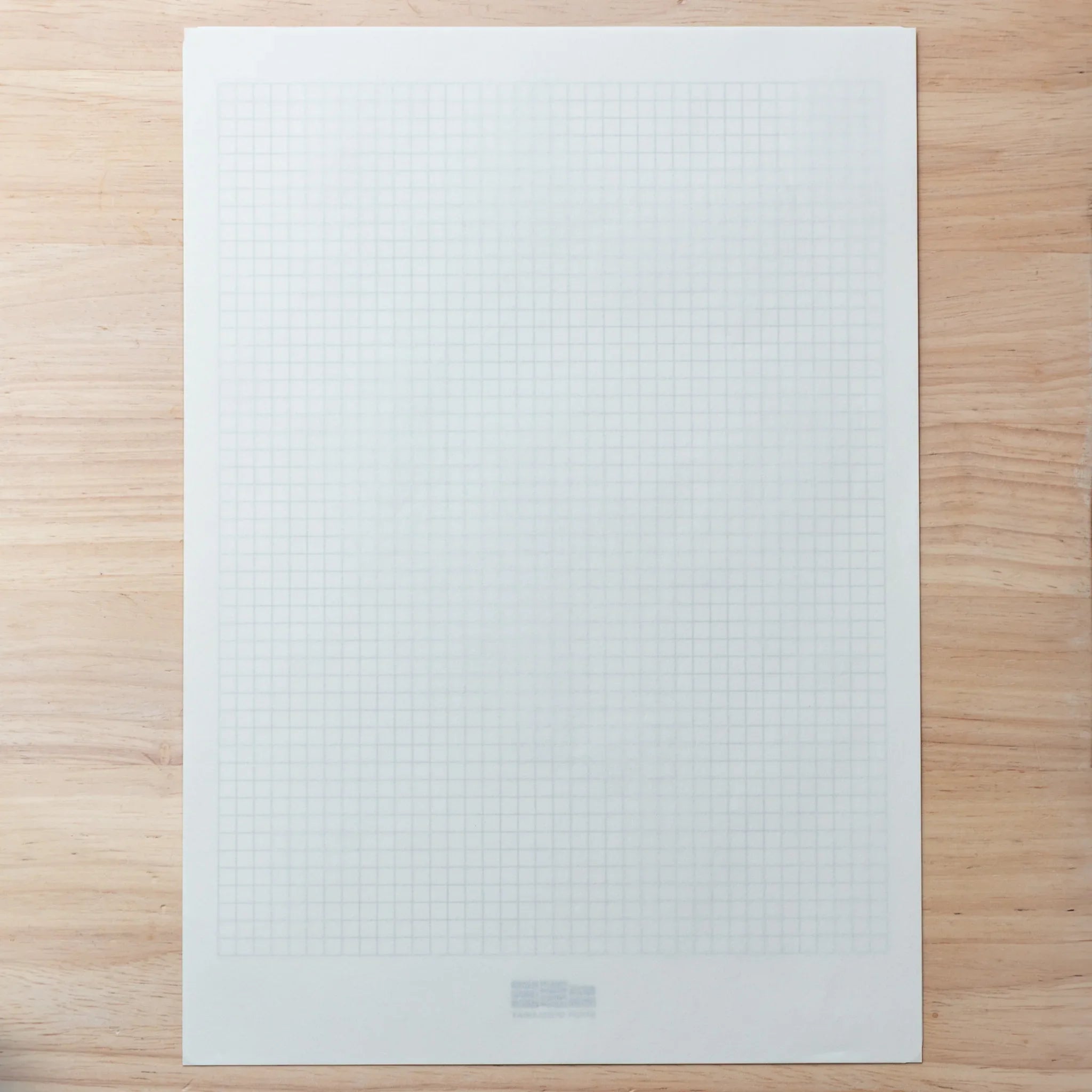 Smooth Onion Skin sheet over blue grid underlay, showing clear translucency for precise writing.