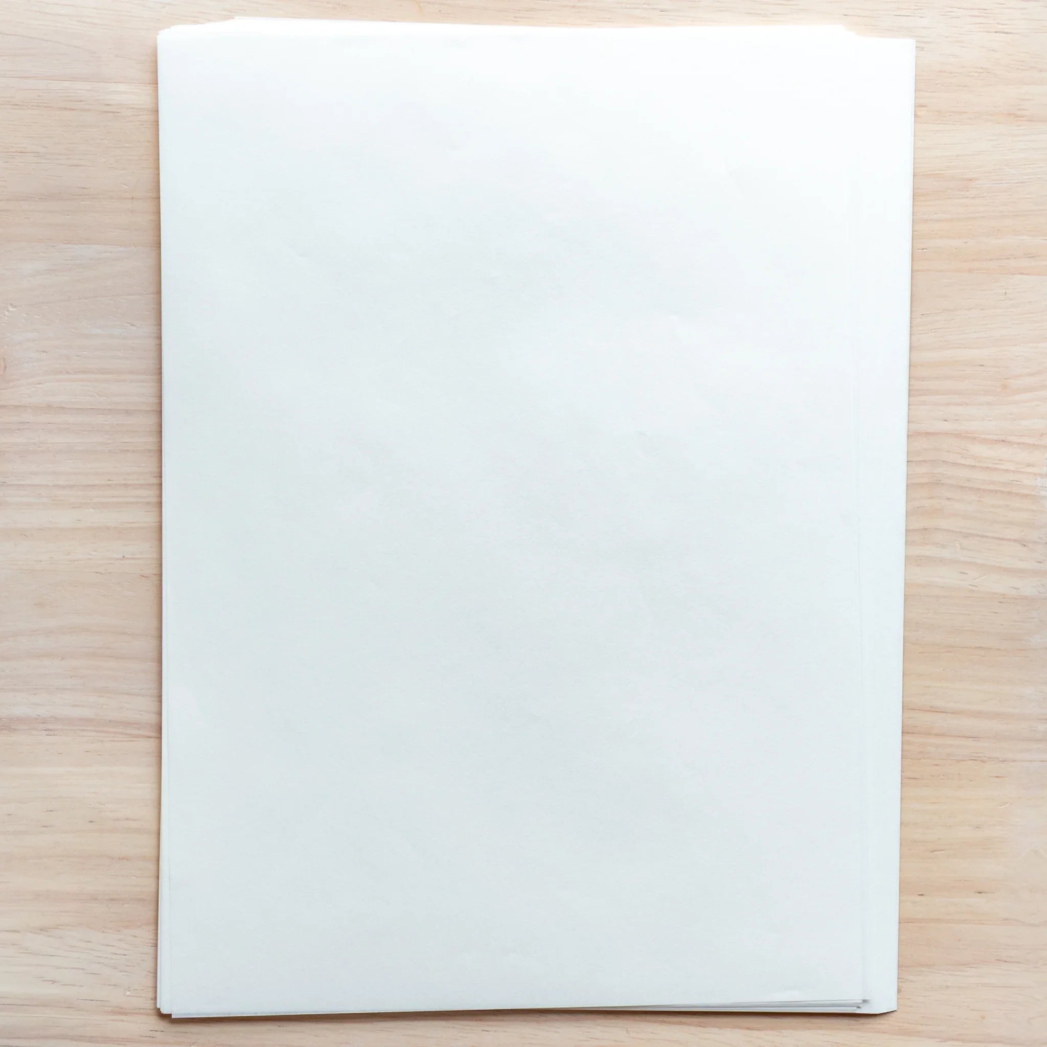 Stack of Smooth Onion Skin A4 loose leaf sheets, ultra-thin and translucent, showing delicate texture.