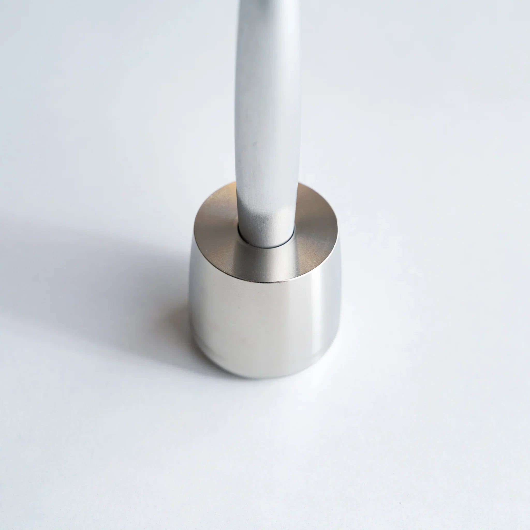 Solid stainless steel pen holder detail showing metal quality and polished finish                             