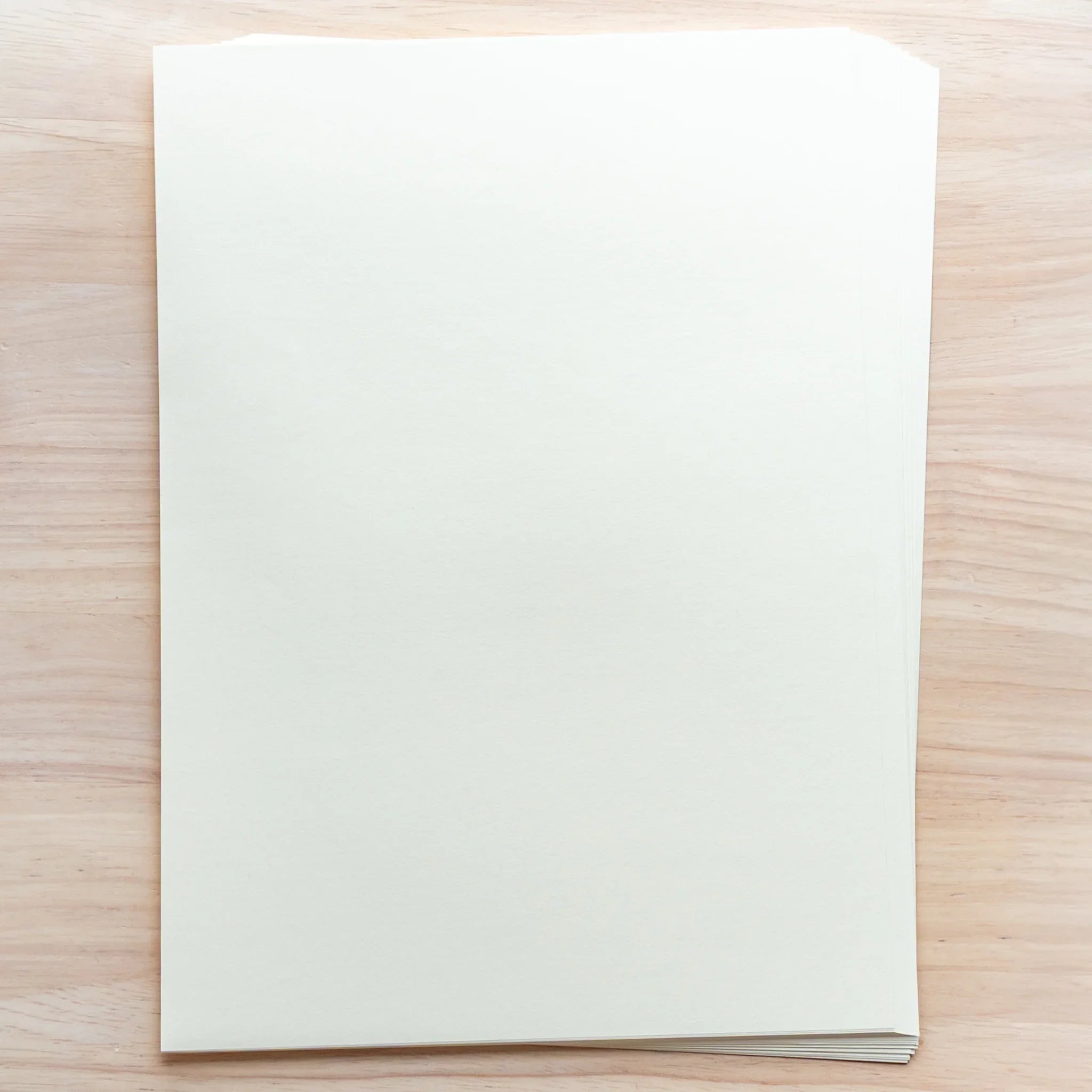 Stack of Japanese Loose Leaf Paper A4 Solist, smooth white lined sheets photographed close-up under soft light.