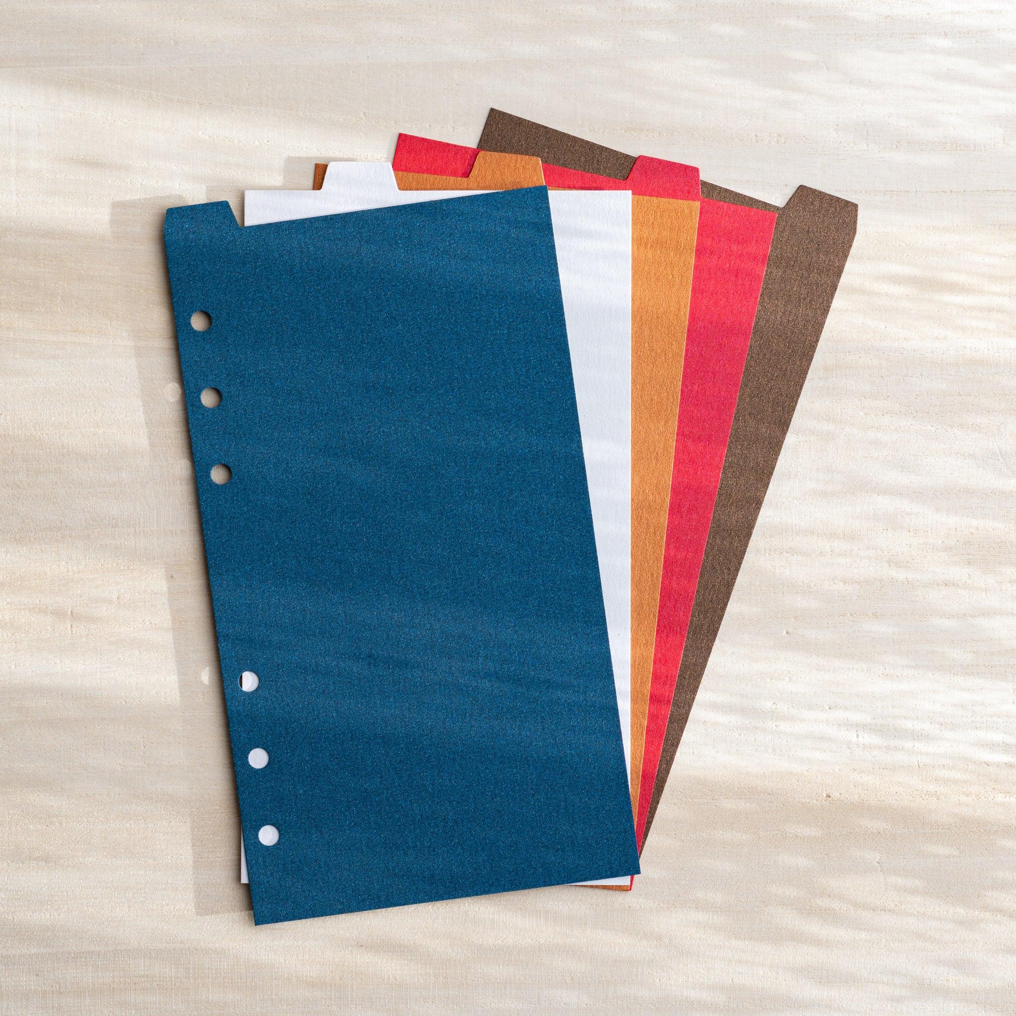 Japanese Stationery Stardream index dividers for Bible size planners fanned out in blue, white, orange, red and brown.
