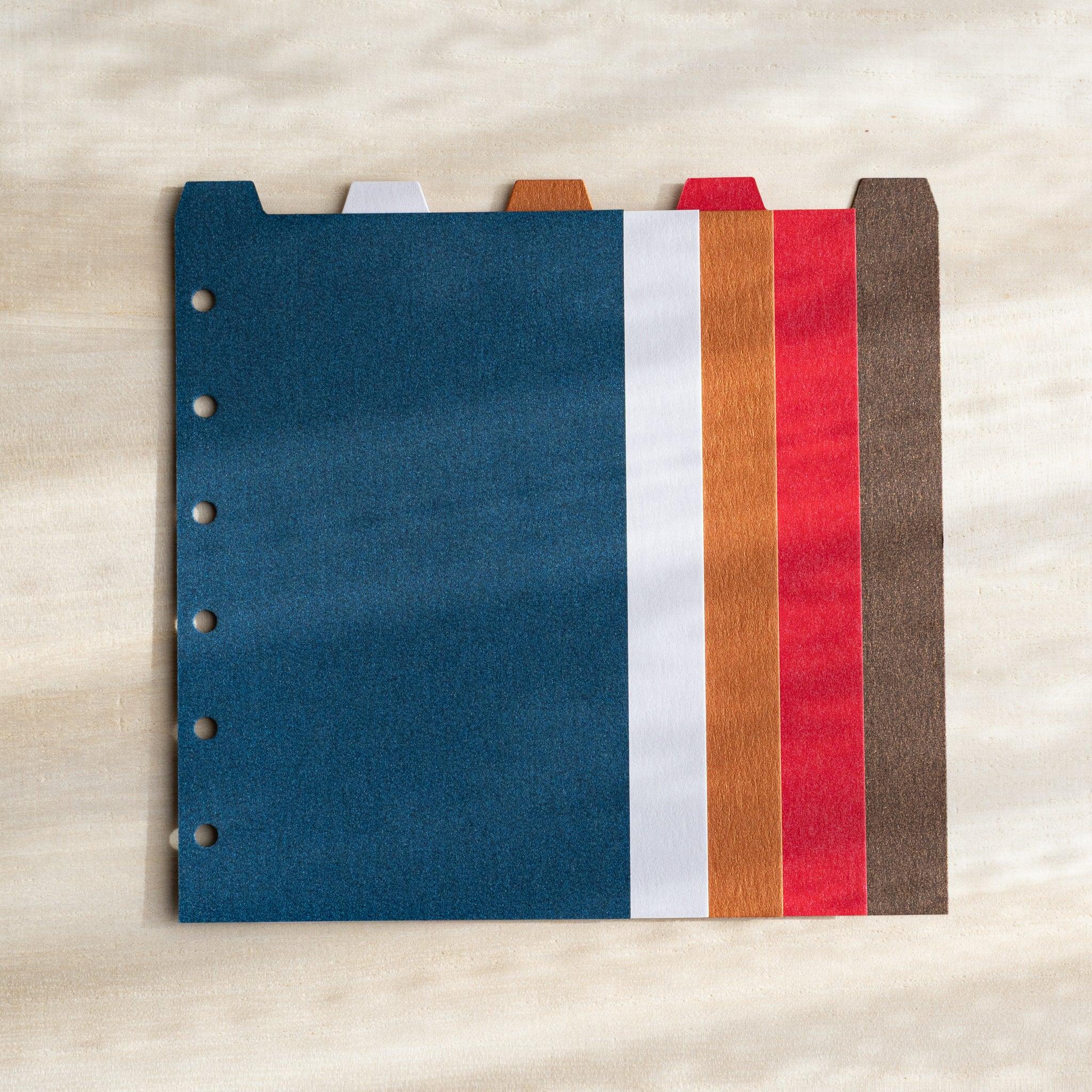 Japanese Stationery Stardream top-tab index dividers for Mini 6 planners in blue, white, orange, red, brown, stacked flat.