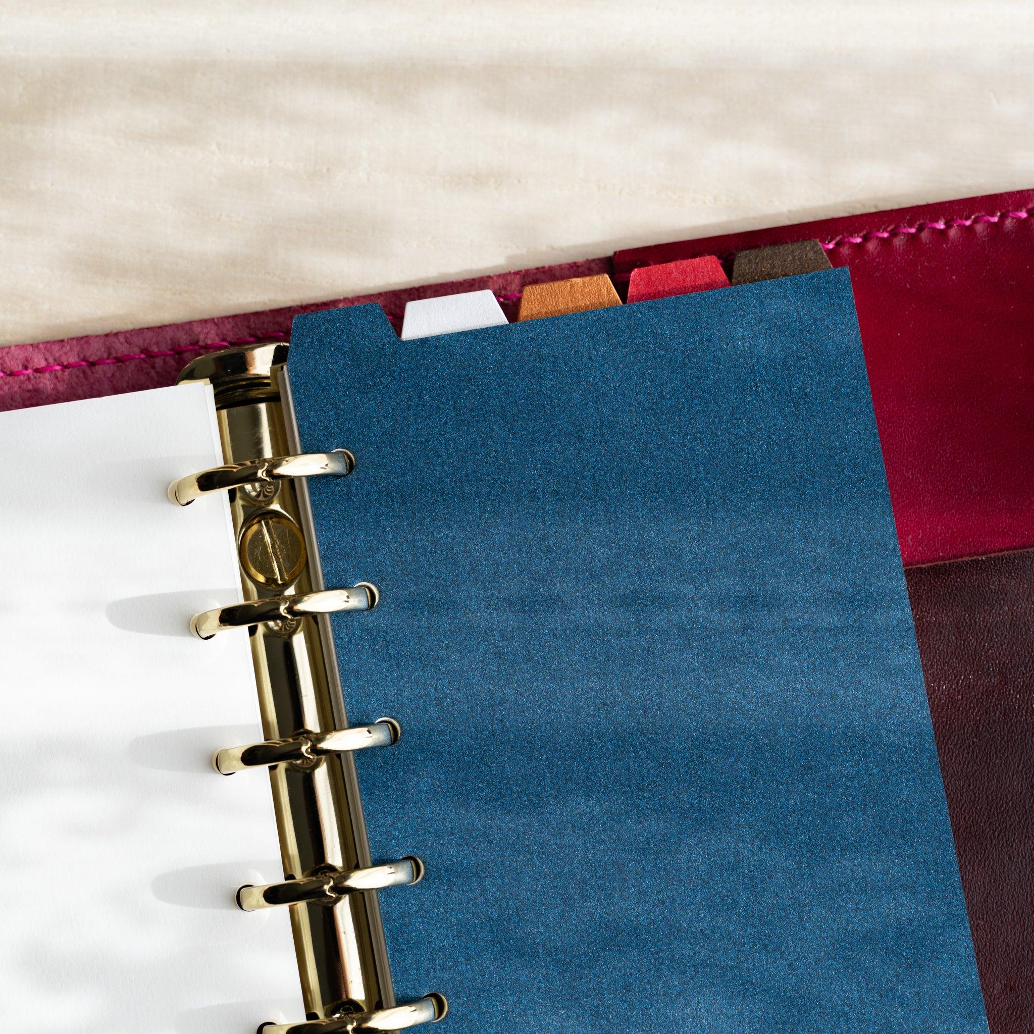 Japanese Stationery Stardream top-tab index dividers for Mini 6 planners inserted in a binder with gold rings and colorful tabs.