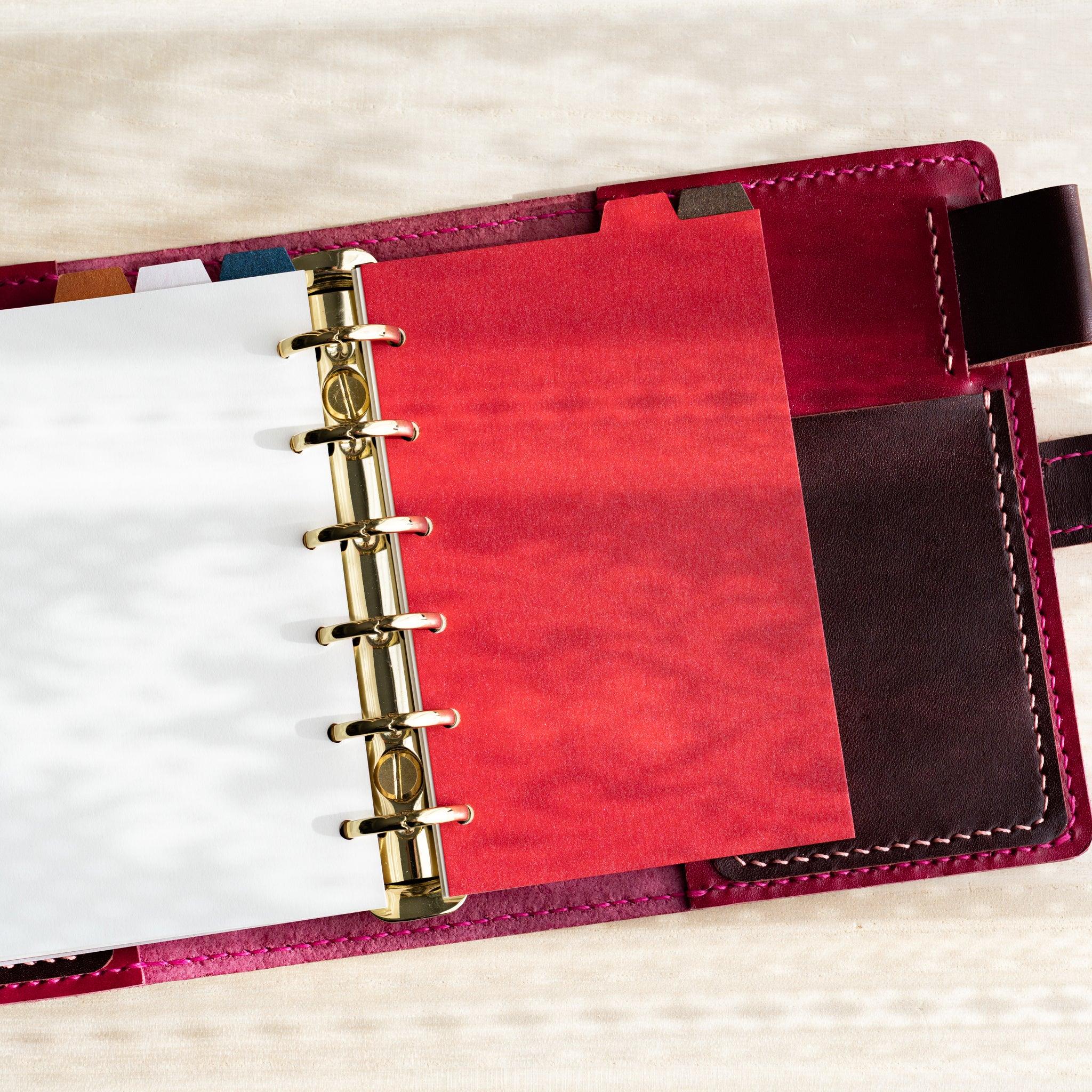 Japanese Stationery Stardream index dividers for Mini 6 planners with a red sheet and colorful tabs in a gold-ring planner.