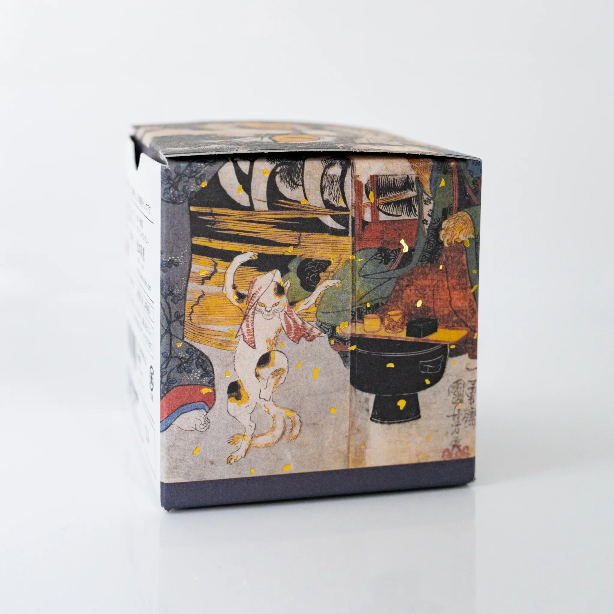 Side panel of TACCIA Kuniyoshi Budounezu box featuring a scene from Kuniyoshi's Cat Stone of Okabe print.