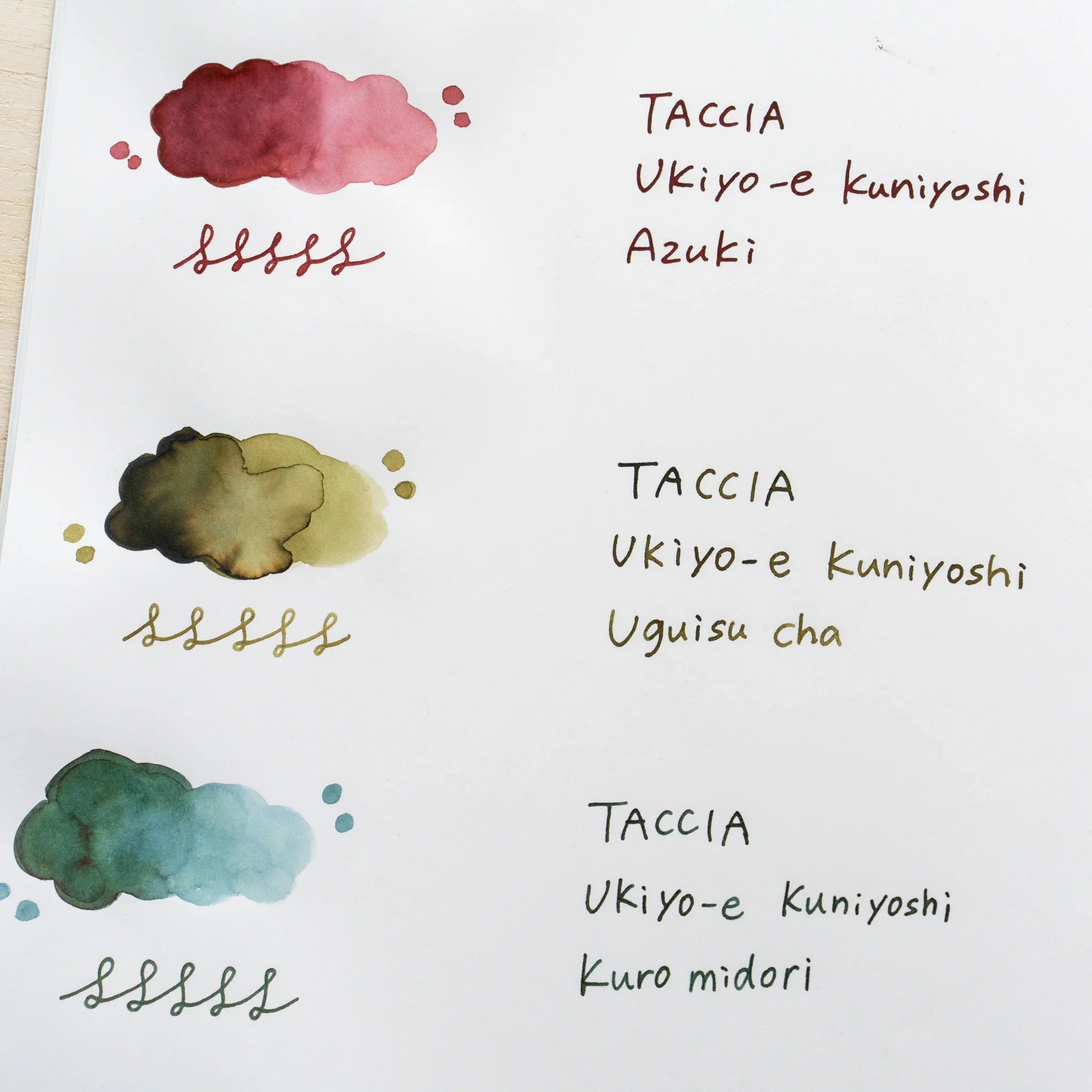 TACCIA Ukiyo-e Kuniyoshi Uguisucha hand-painted swatch shown with neighboring ink colors on YU-SARI notebook.