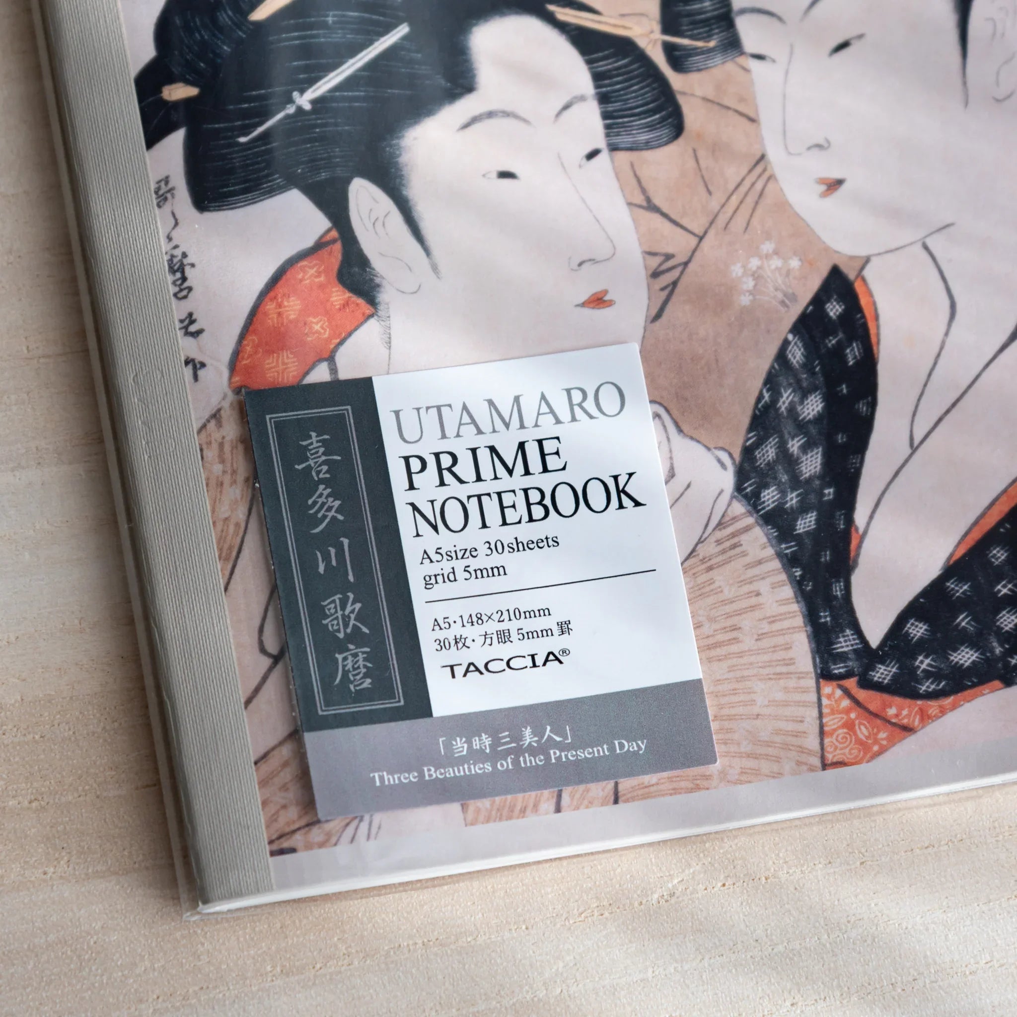 Close-up of Taccia Japanese notebook cover showing Utamaro ukiyo-e art and Prime Notebook label.