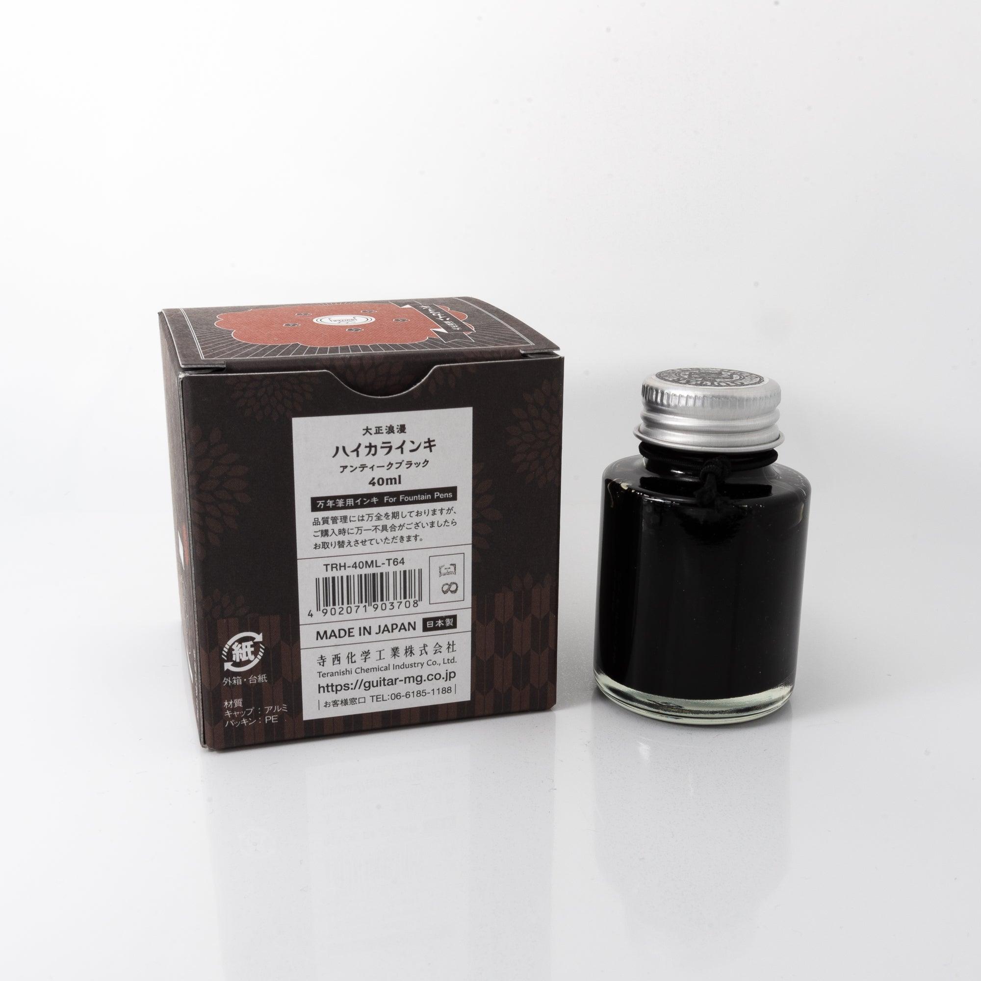 Top view of the Taisho Romance Antique Black ink bottle, showcasing its rich black ink, surrounded by natural wooden tones.  