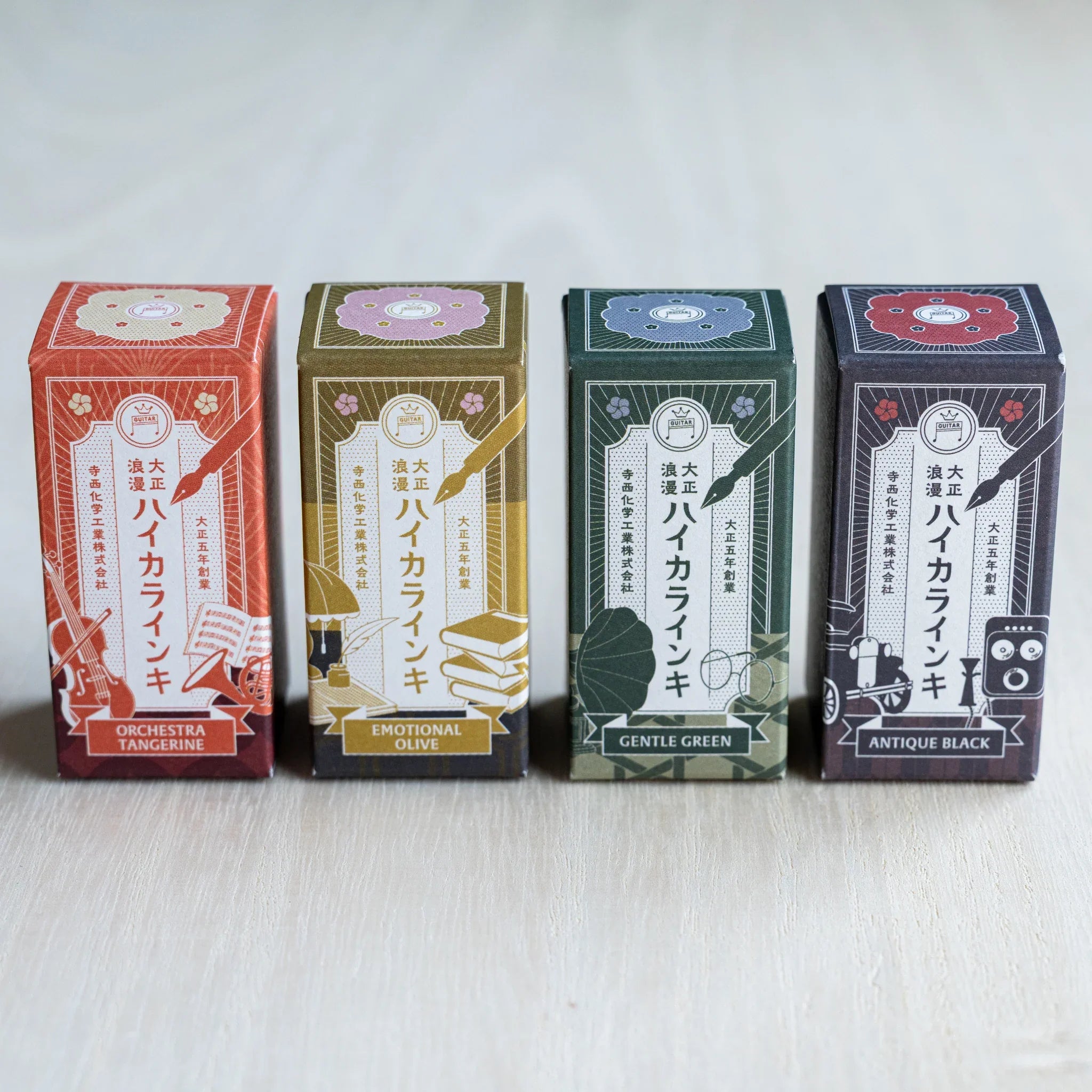 Four illustrated Taisho Romance ink boxes in a row for Orchestra Tangerine, Emotional Olive, Gentle Green and Antique Black