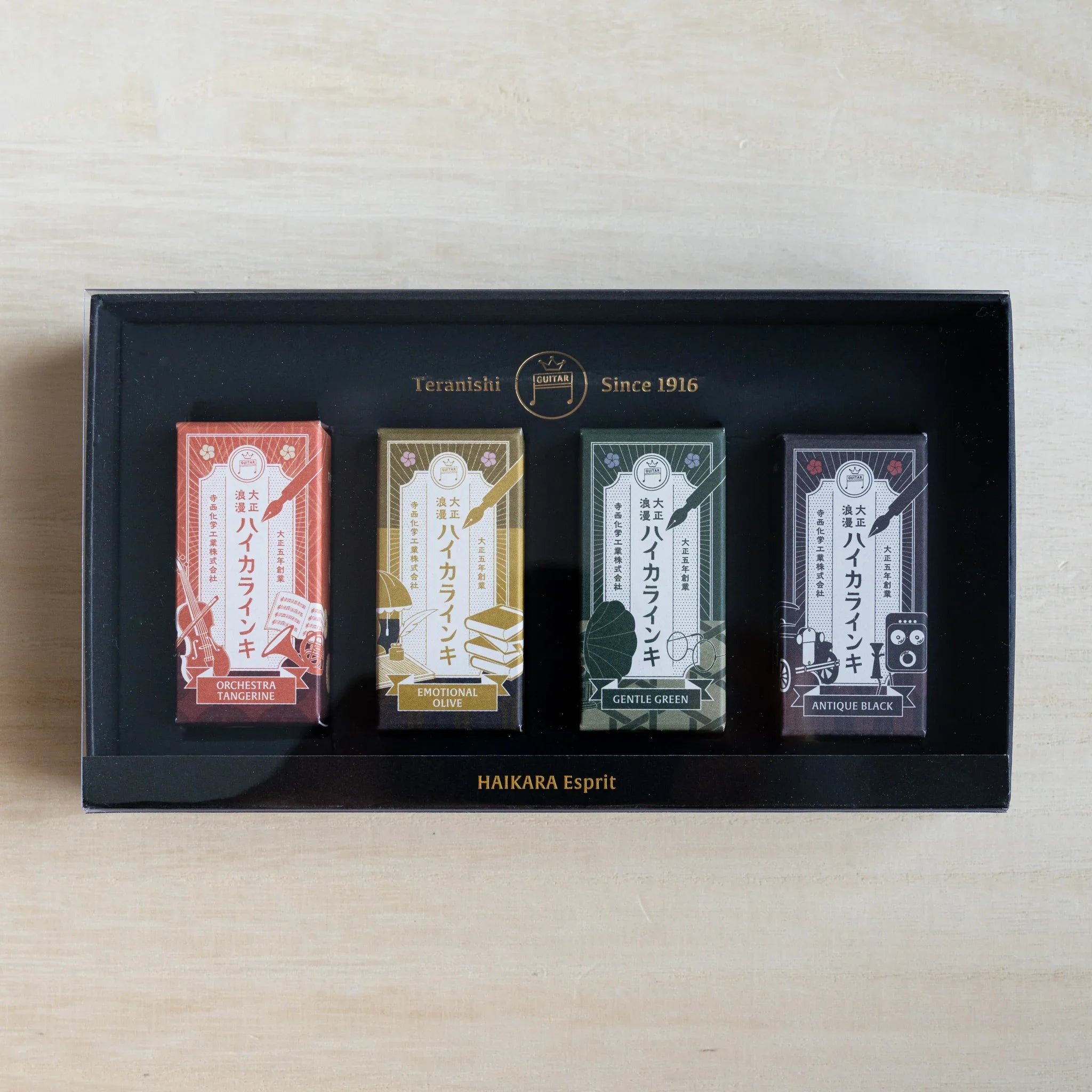Open black gift box of the HAIKARA Esprit set with four individually wrapped 12 ml ink bottles inside