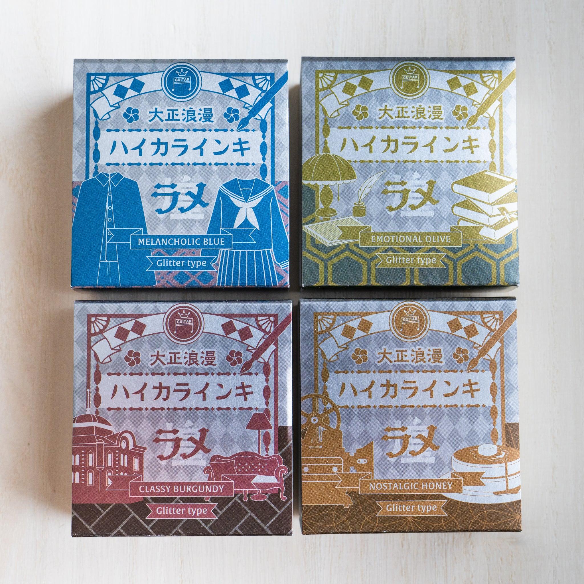 Four Taisho Romance shimmer ink boxes in silver foil, seen from above, one for each colour of the range