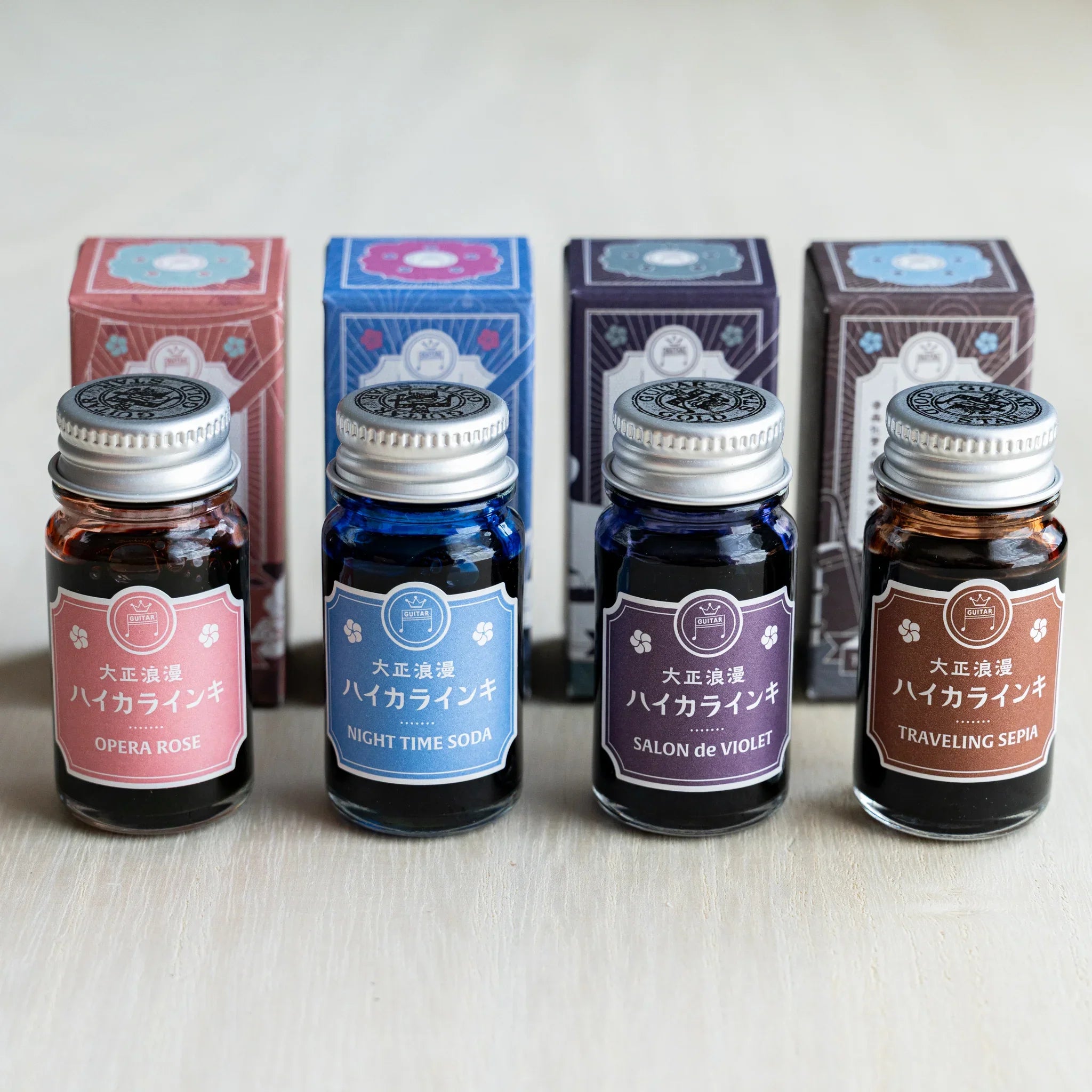 Taisho Romance HAIKARA Metropolis ink set, four 12 ml bottles standing in front of their illustrated boxes