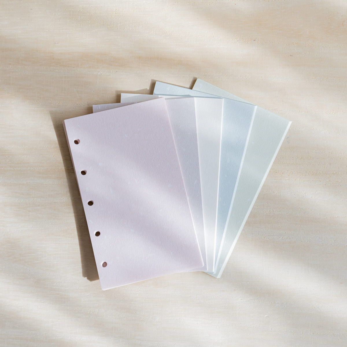 Feather Waltz M5 refill sheets fanned in five pastel colors with a pale pink sheet on top