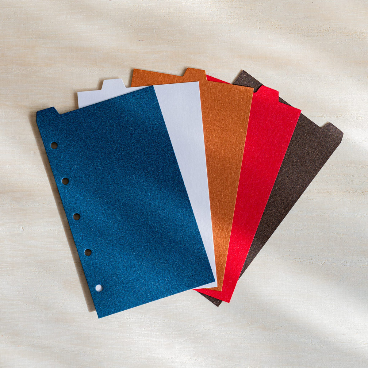 Five Stardream M5 index dividers fanned in night blue, opal, copper, ruby and bronze with staggered top tabs