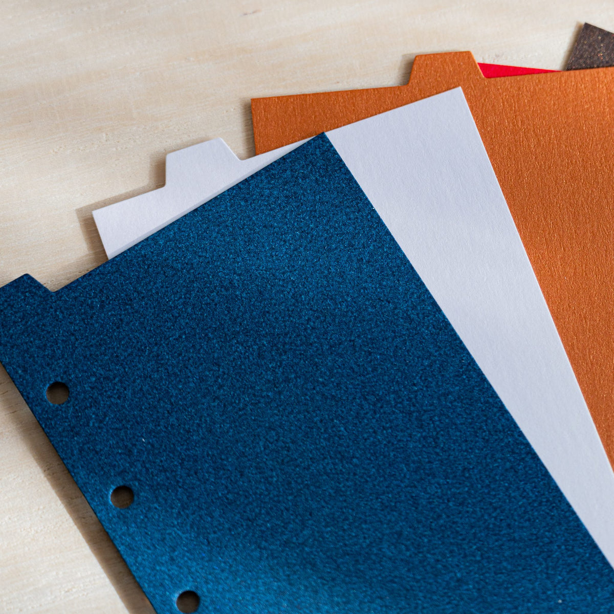 Close-up of Stardream index dividers showing metallic shimmer on night blue, opal and copper sheets