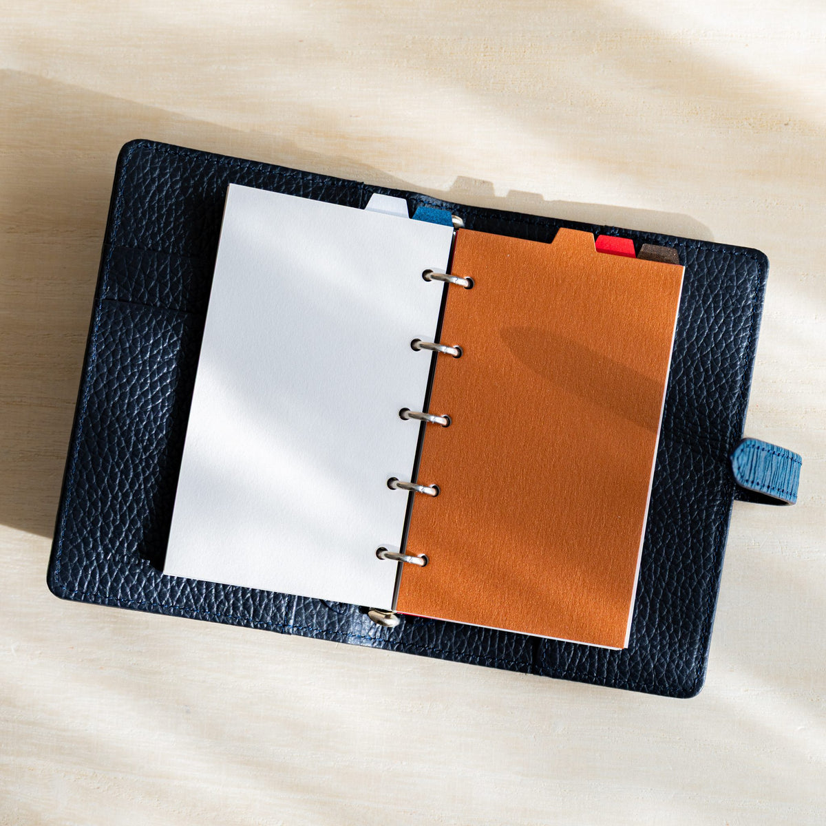 Open navy planner with opal and copper Stardream M5 dividers, top tabs in a row