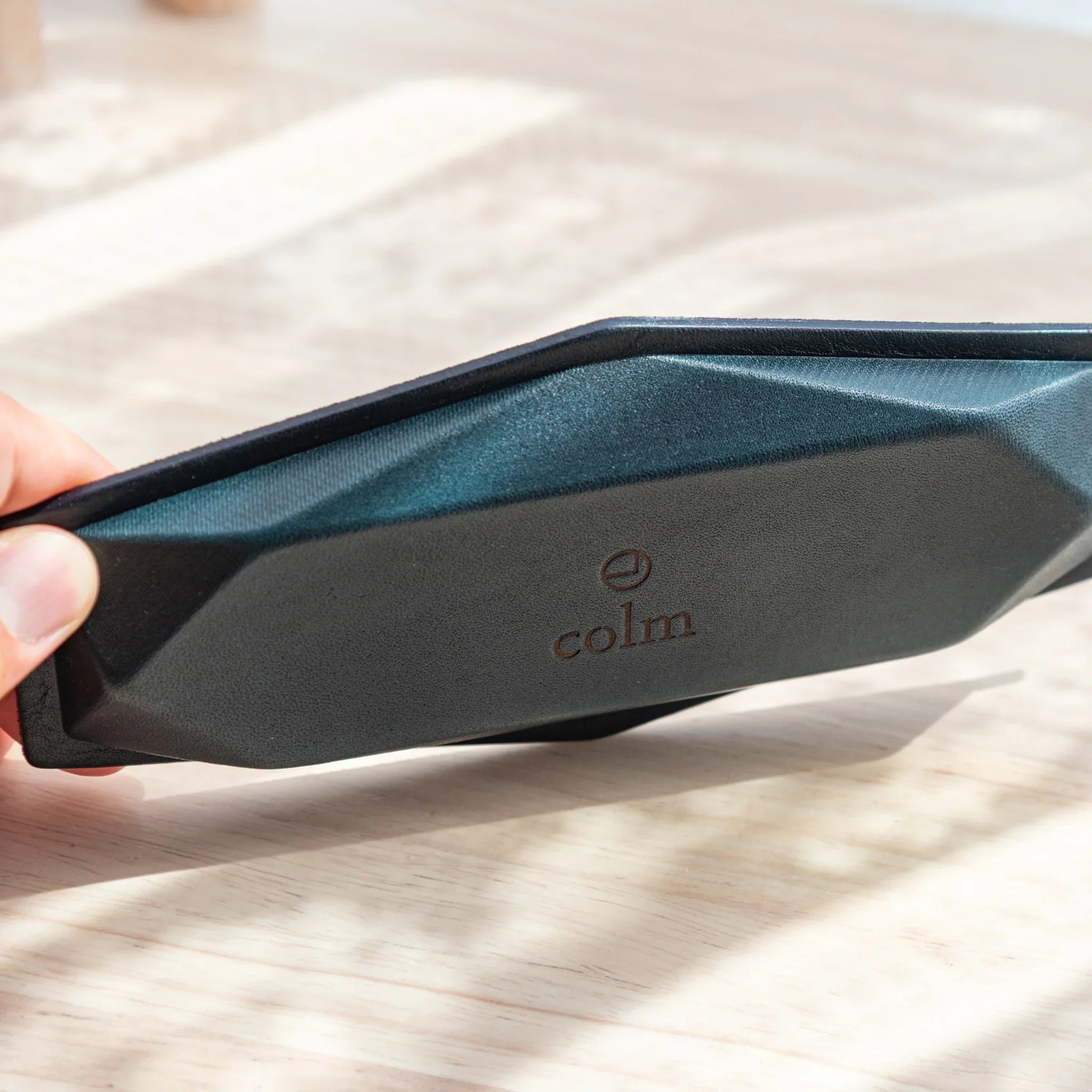 Underside of Japanese Pen Tray with colm logo, made of vegetable-tanned Tatsuno leather in rich brown.