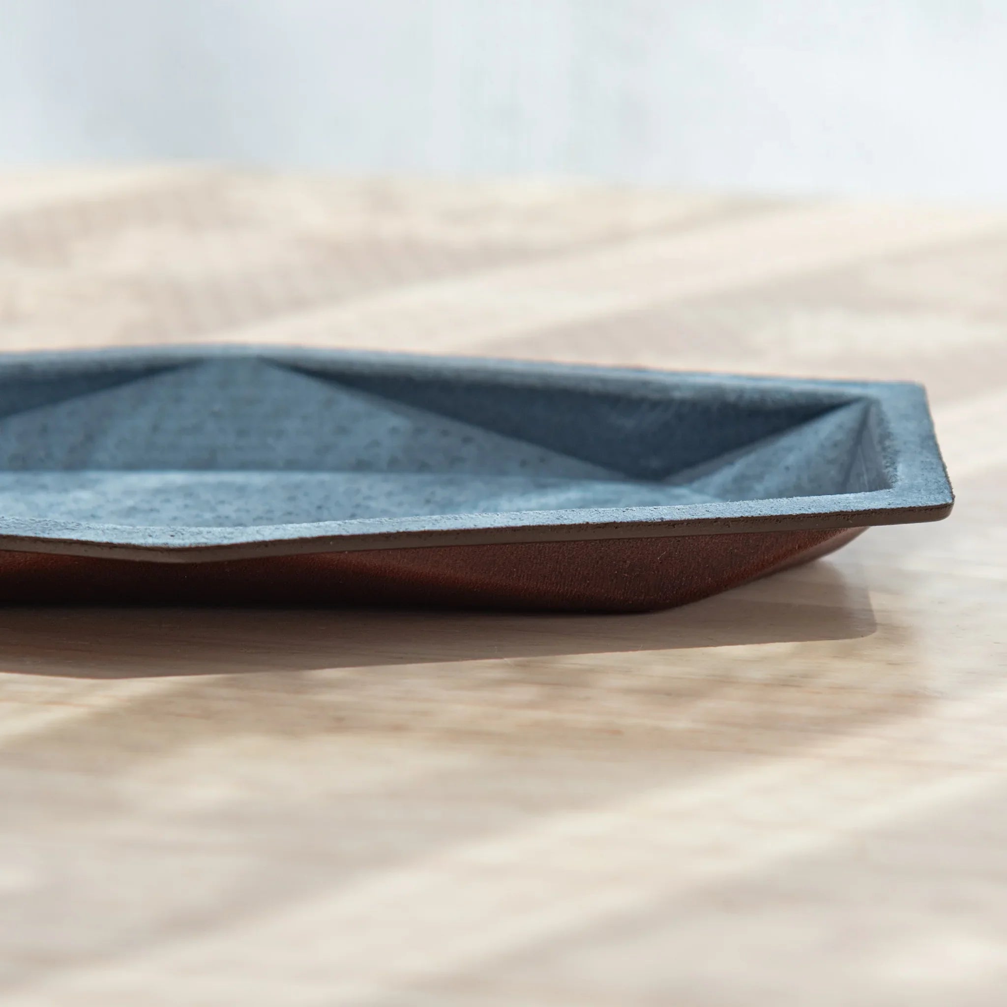 Side view of the Japanese Pen Tray showing the slim silhouette and sturdy leather base.