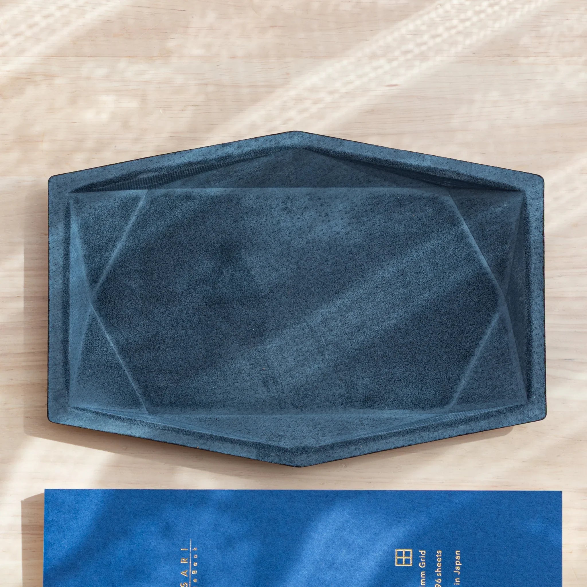 Overhead view of the empty blue Japanese Pen Tray with faceted design.