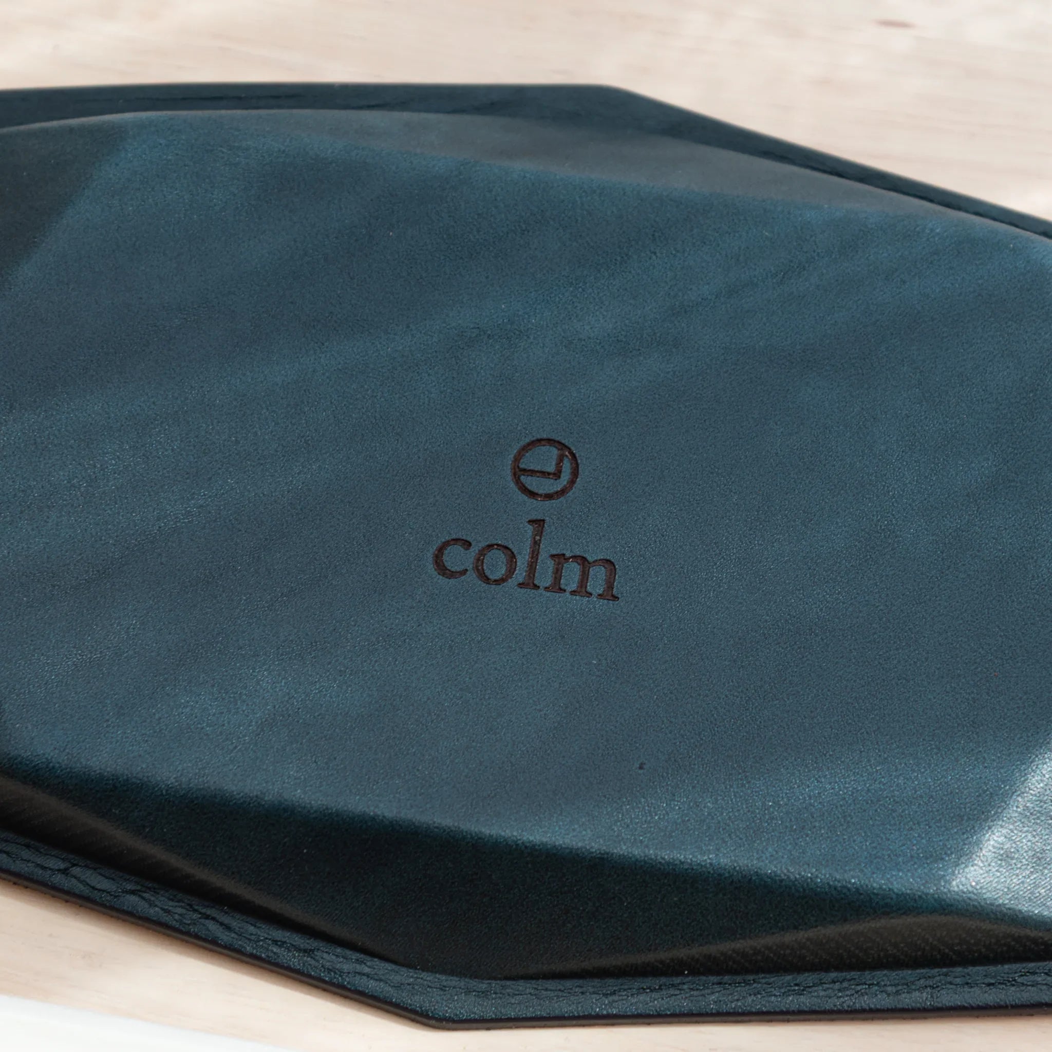 Close-up of the leather back of the Japanese Pen Tray with the colm logo centered.