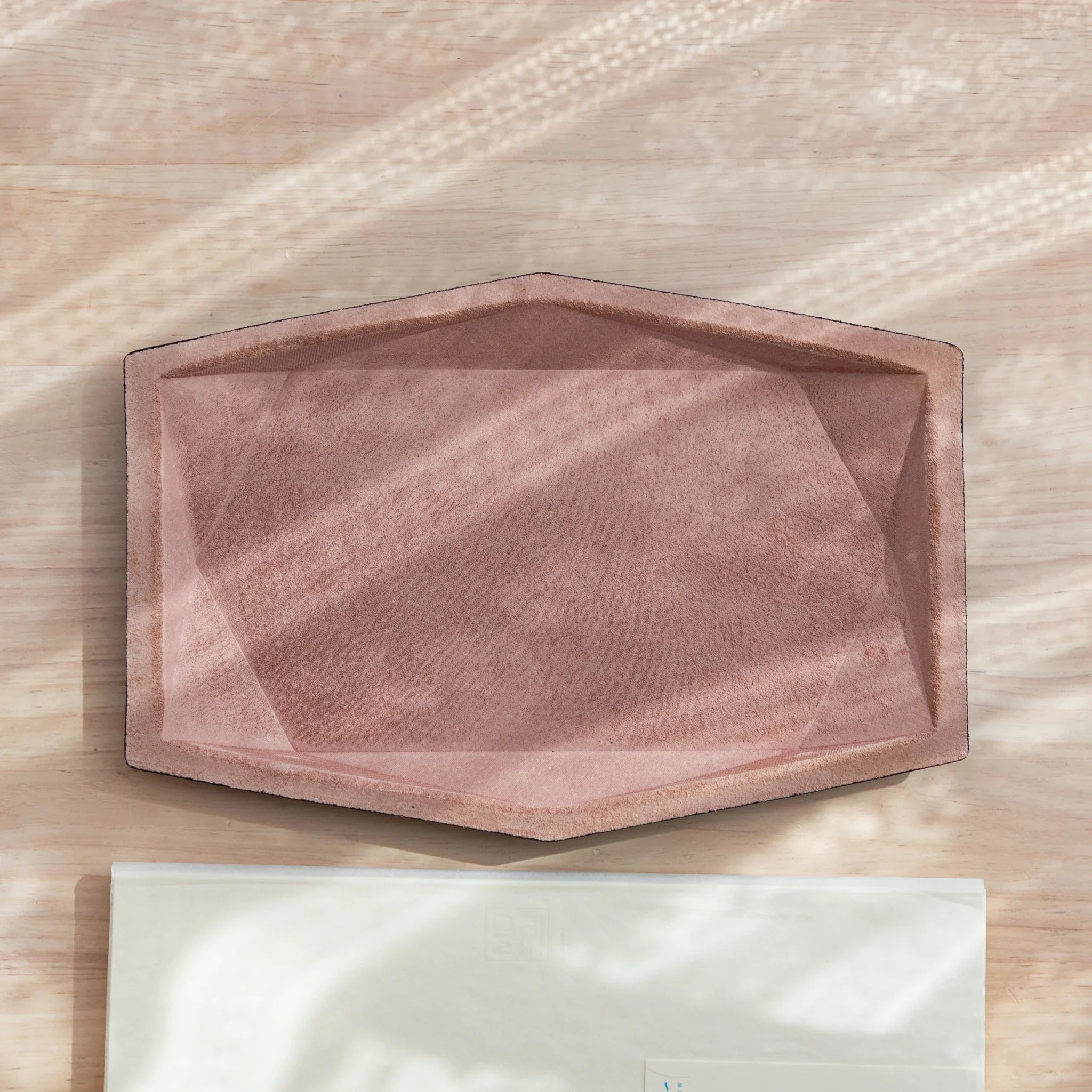  Top-down view of a Japanese Pen Tray with a pink suede surface.