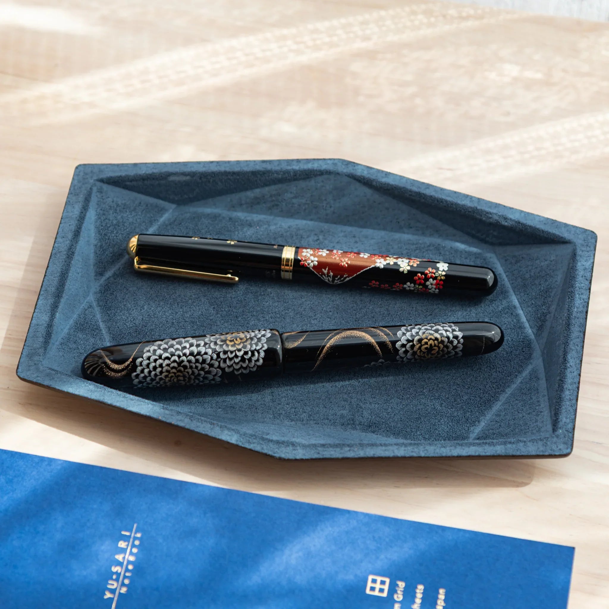 Japanese Pen Tray with blue suede interior holding two fountain pens.