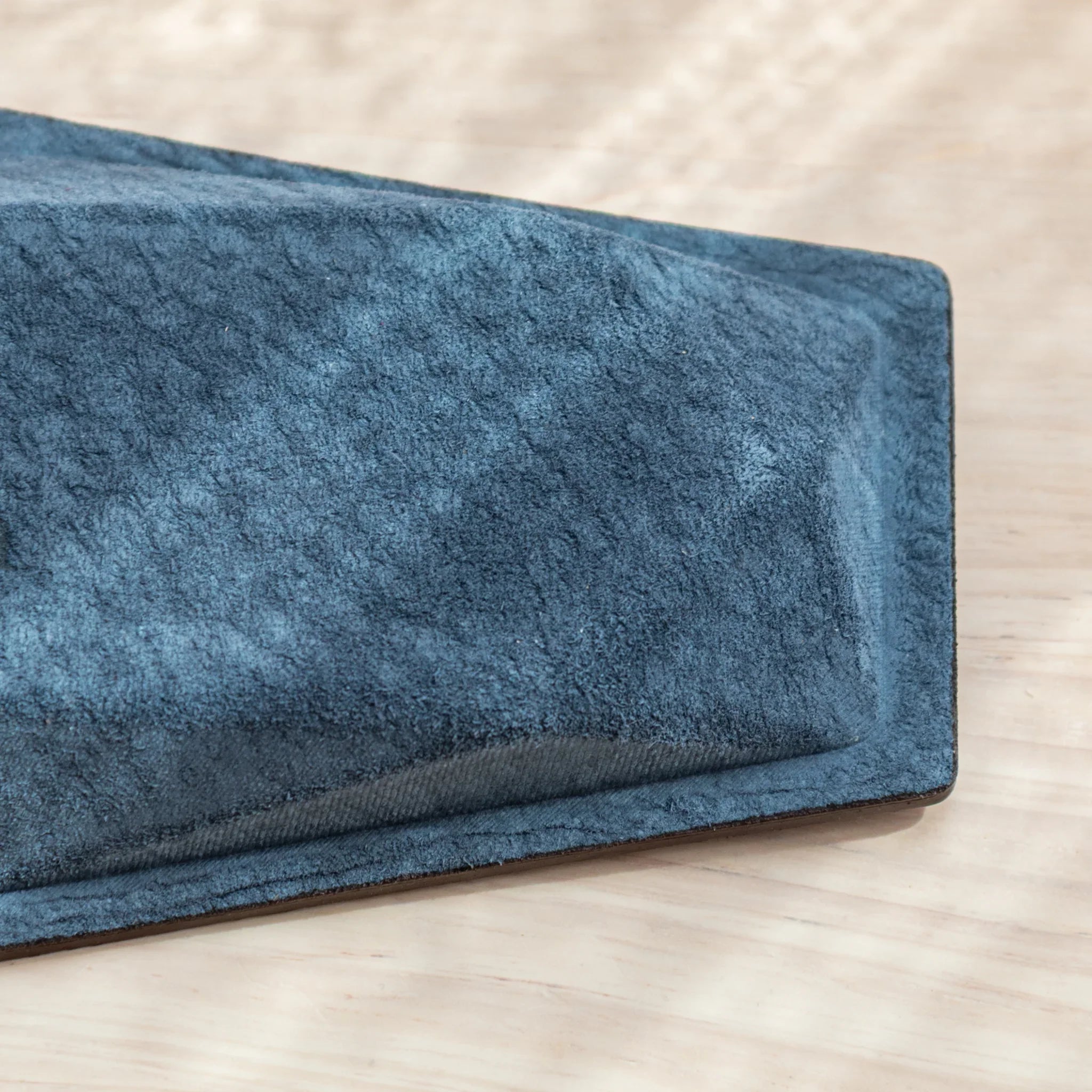Textured Teal-Blue suede bottom corner of the Japanese Pen Tray by Tatsuno.