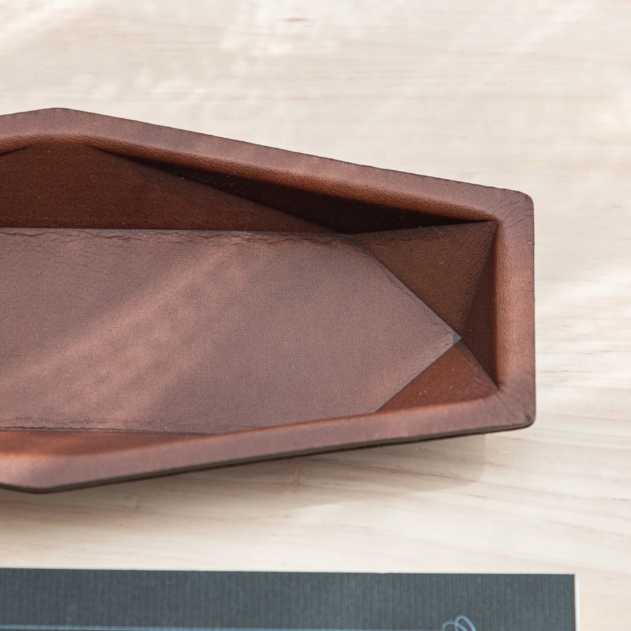 Close-up of the interior corner stitching on the dark brown Japanese Pen Tray by Tatsuno.