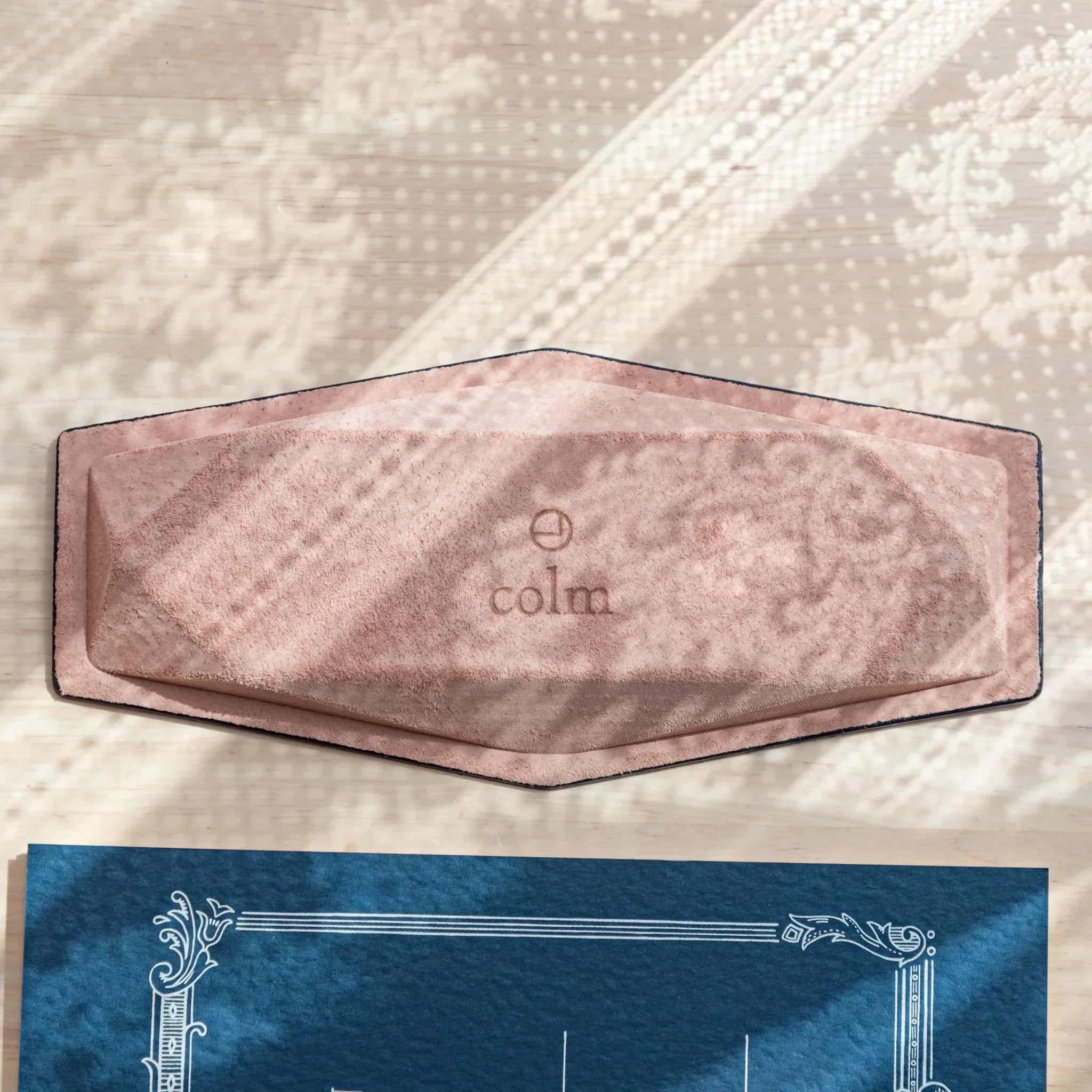 Flat view of leather bottom of Japanese Pen Tray with “colm” logo and suede texture.