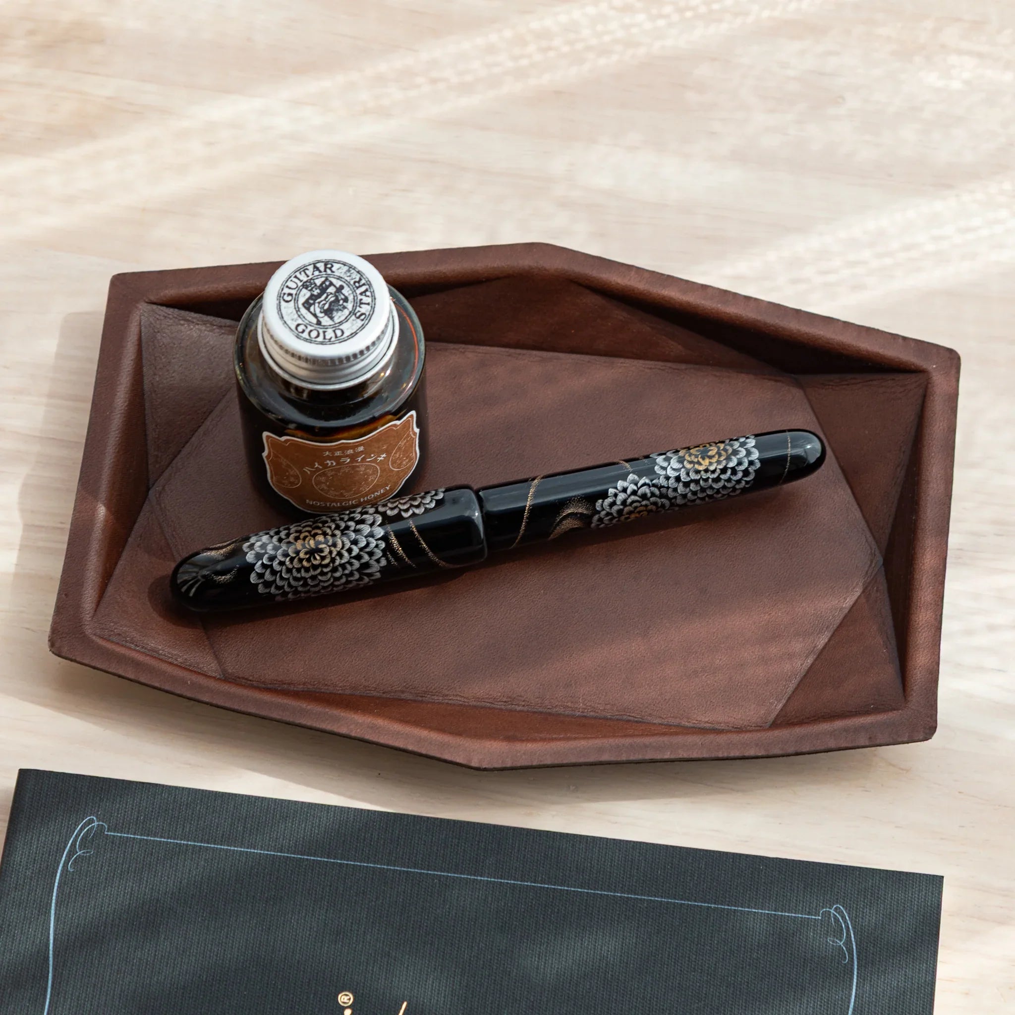 Brown Japanese Pen Tray with black and gold Japanese Fountain Pen and ink bottle.
