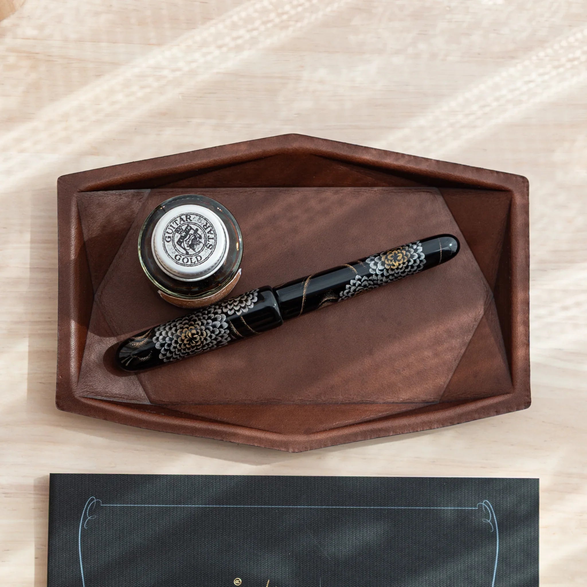 Brown Japanese Pen Tray with black and gold Japanese Fountain Pen and ink bottle.